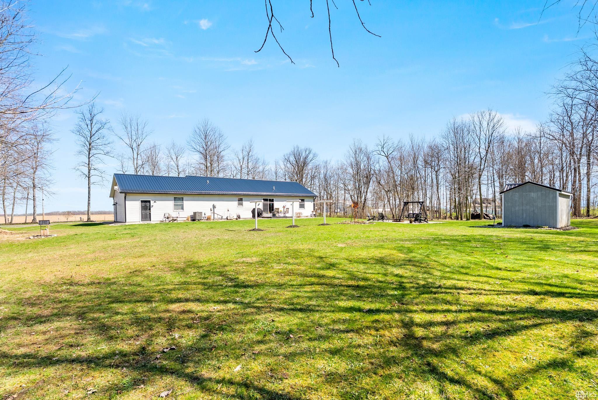 View of grassy yard with an outbuilding