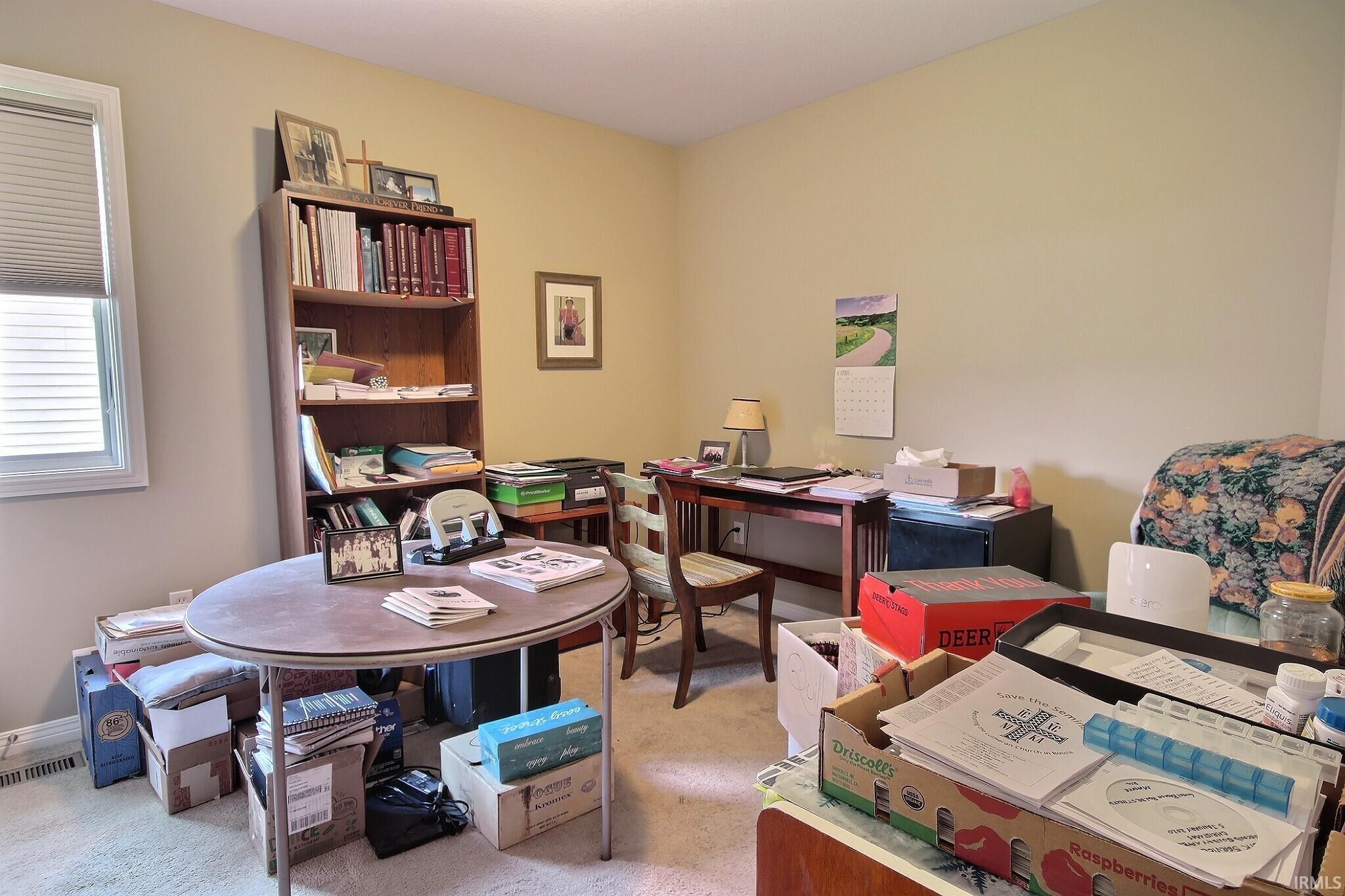 Office area featuring light carpet