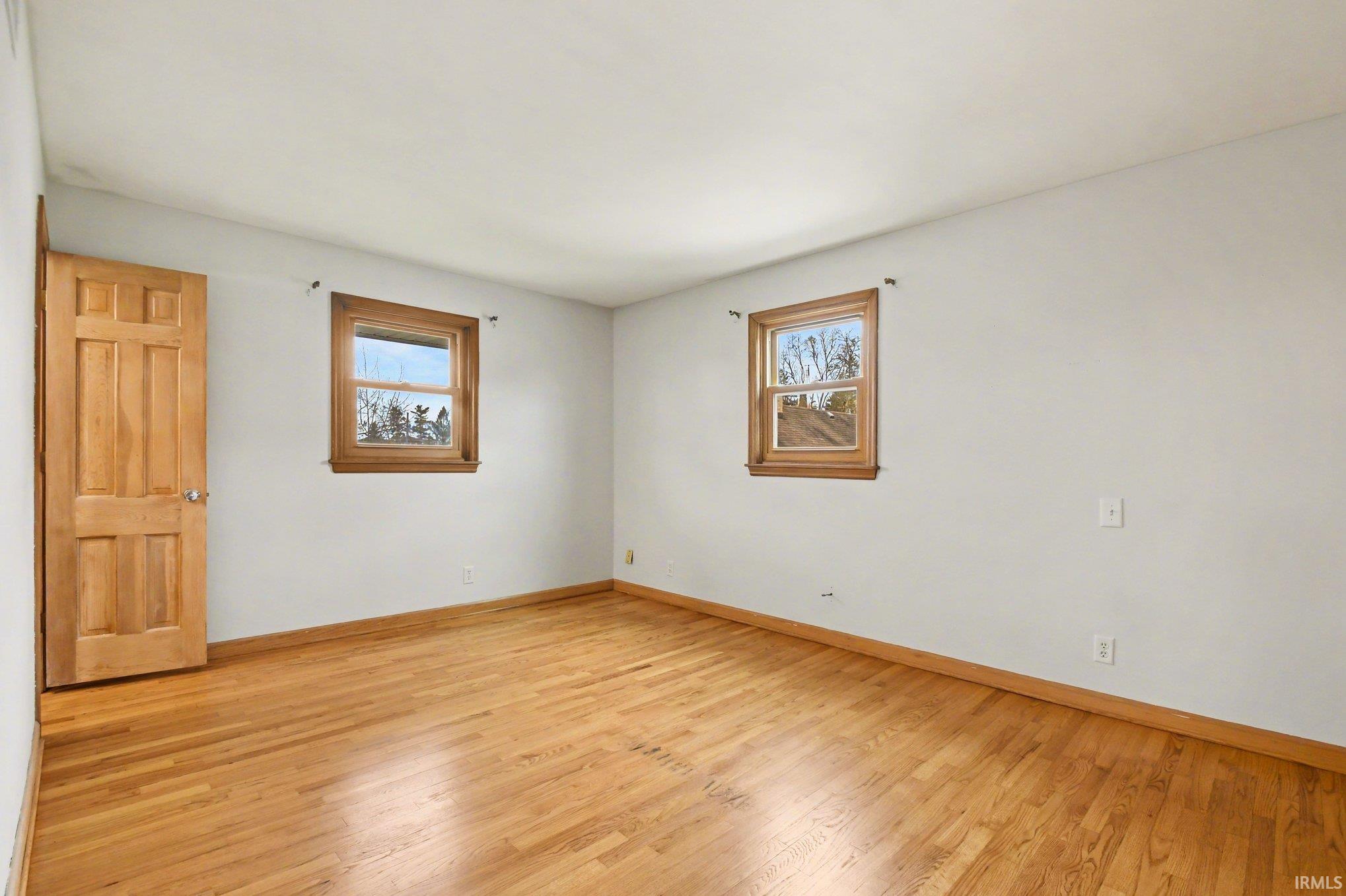 Spare room with light wood-style flooring and baseboards