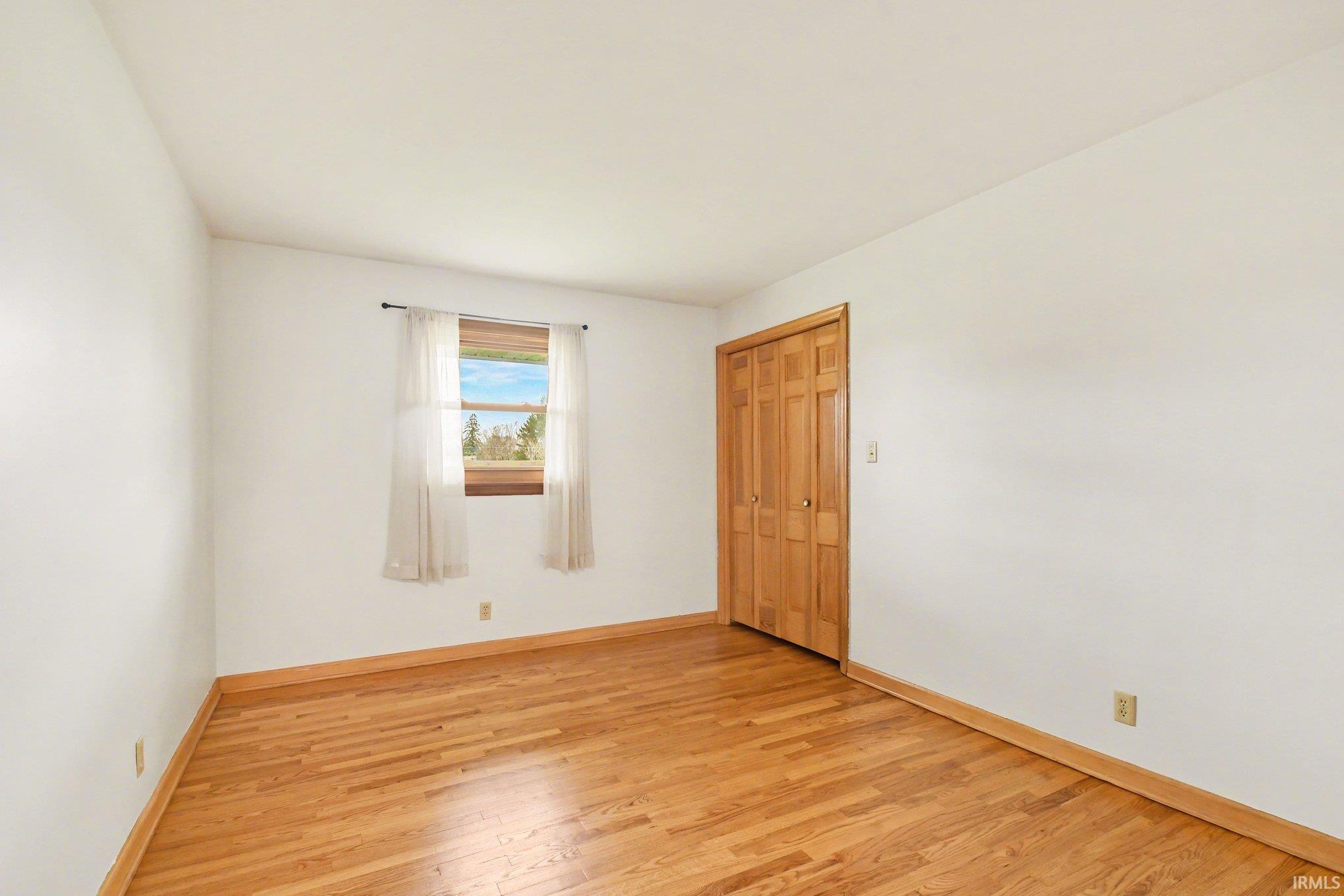 Empty room with light wood-style flooring