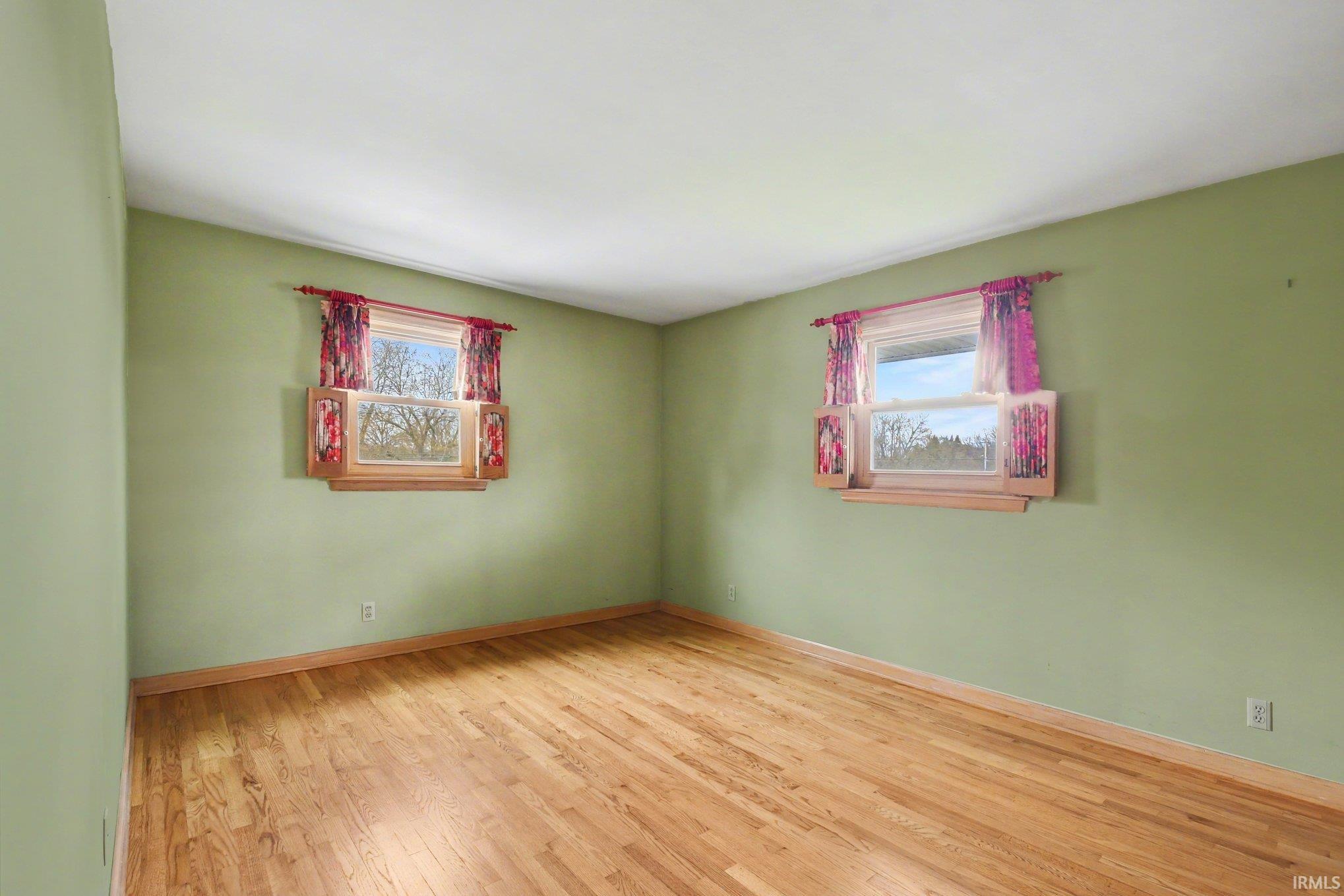 Spare room with light wood finished floors and baseboards