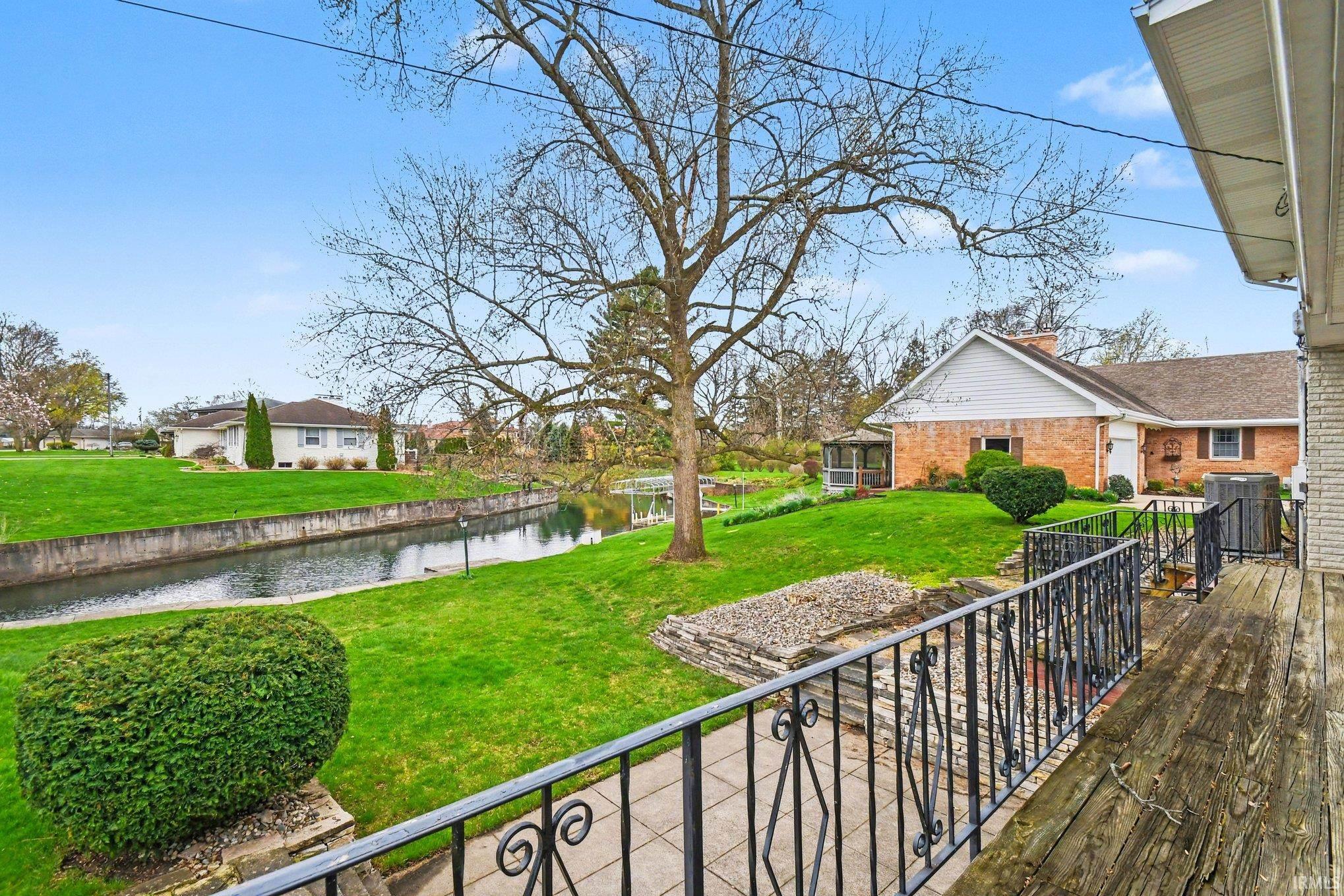 View of green lawn with a water view and a residential view