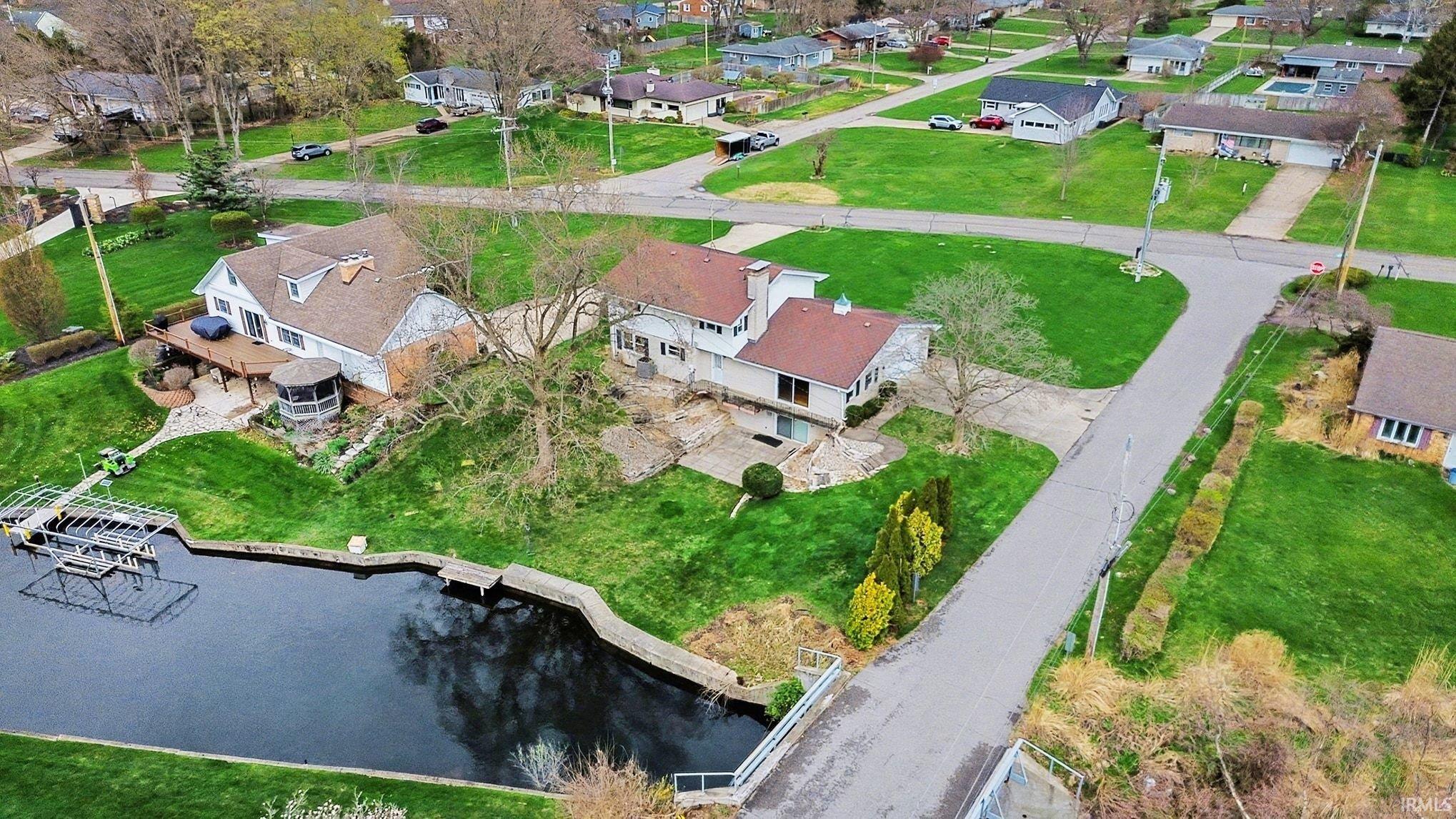 Aerial view of residential area featuring a nearby body of water