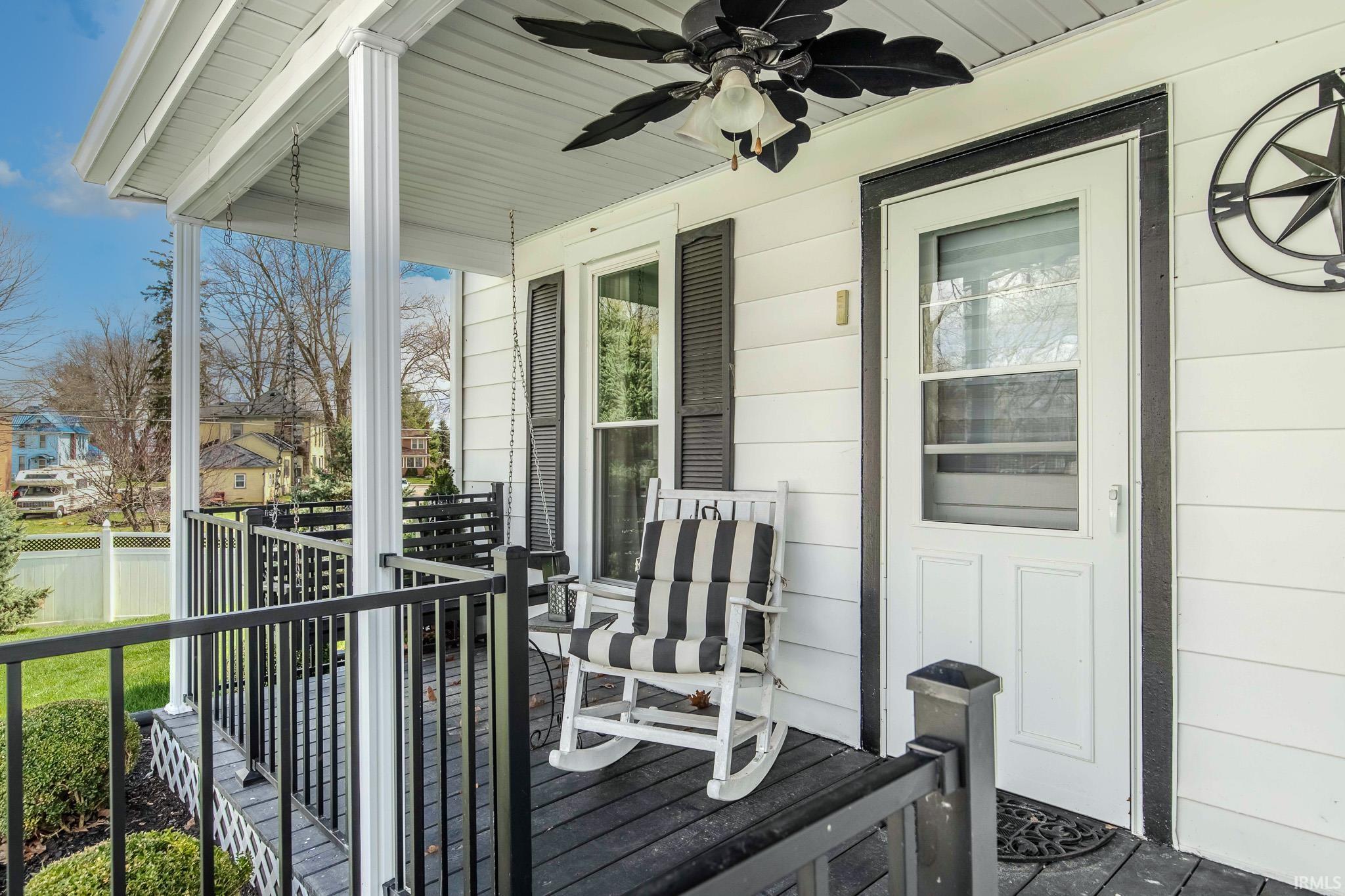 Wooden porch with a ceiling fan