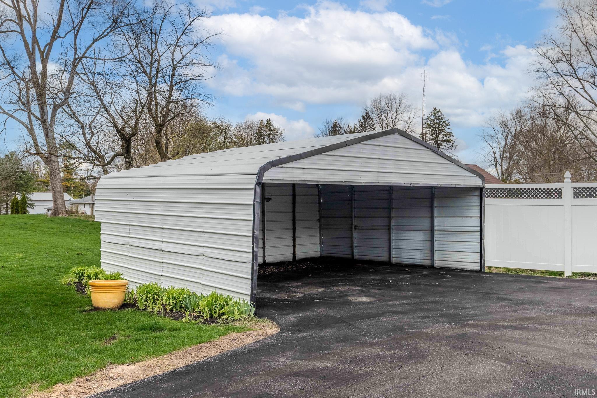 Garage with a detached carport and driveway