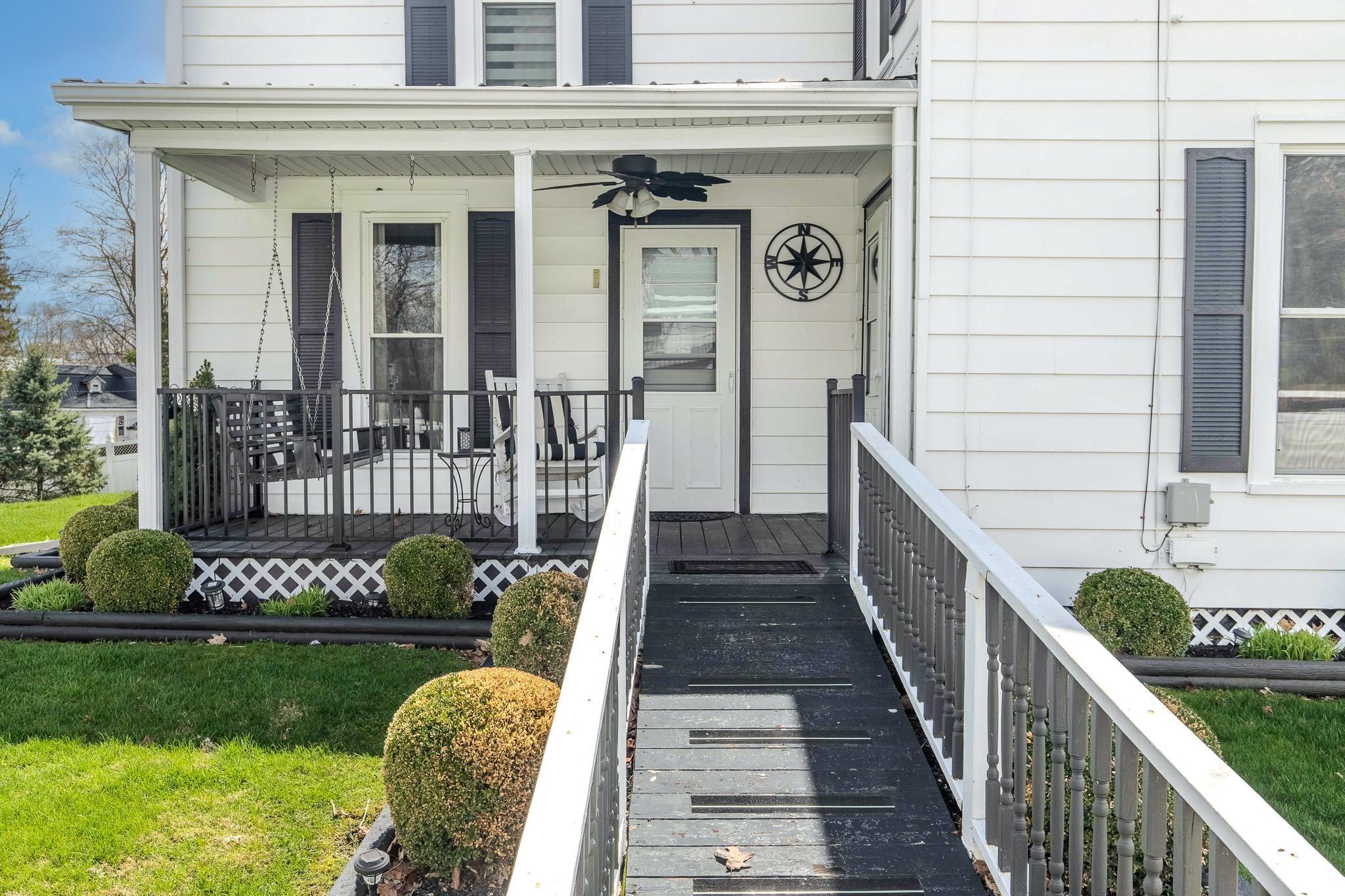 Entrance to property with a porch and ceiling fan