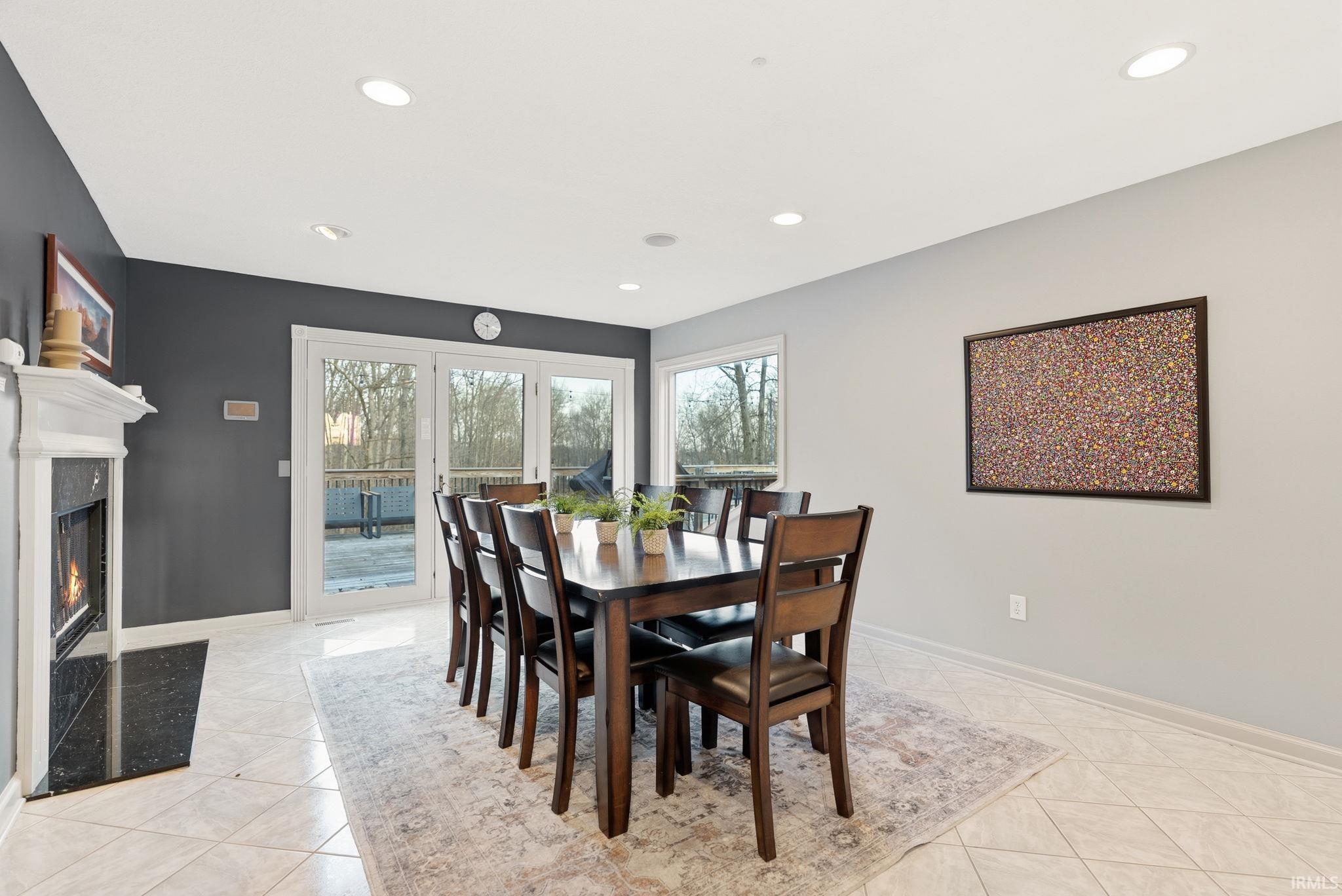 Dining space featuring healthy amount of natural light, a high end fireplace, and recessed lighting