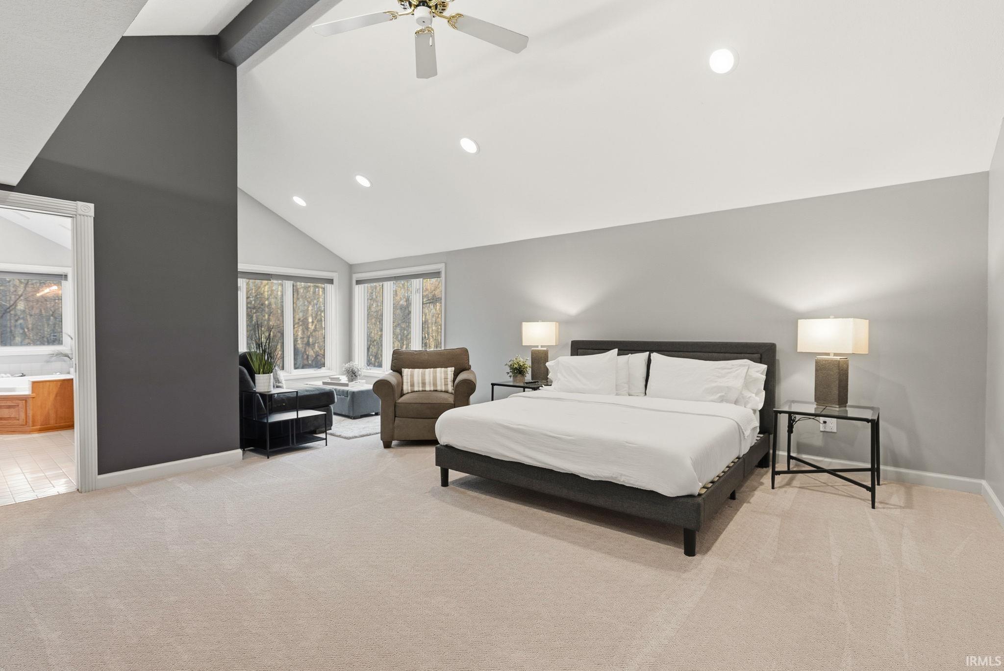 Bedroom with a ceiling fan, light carpet, and recessed lighting