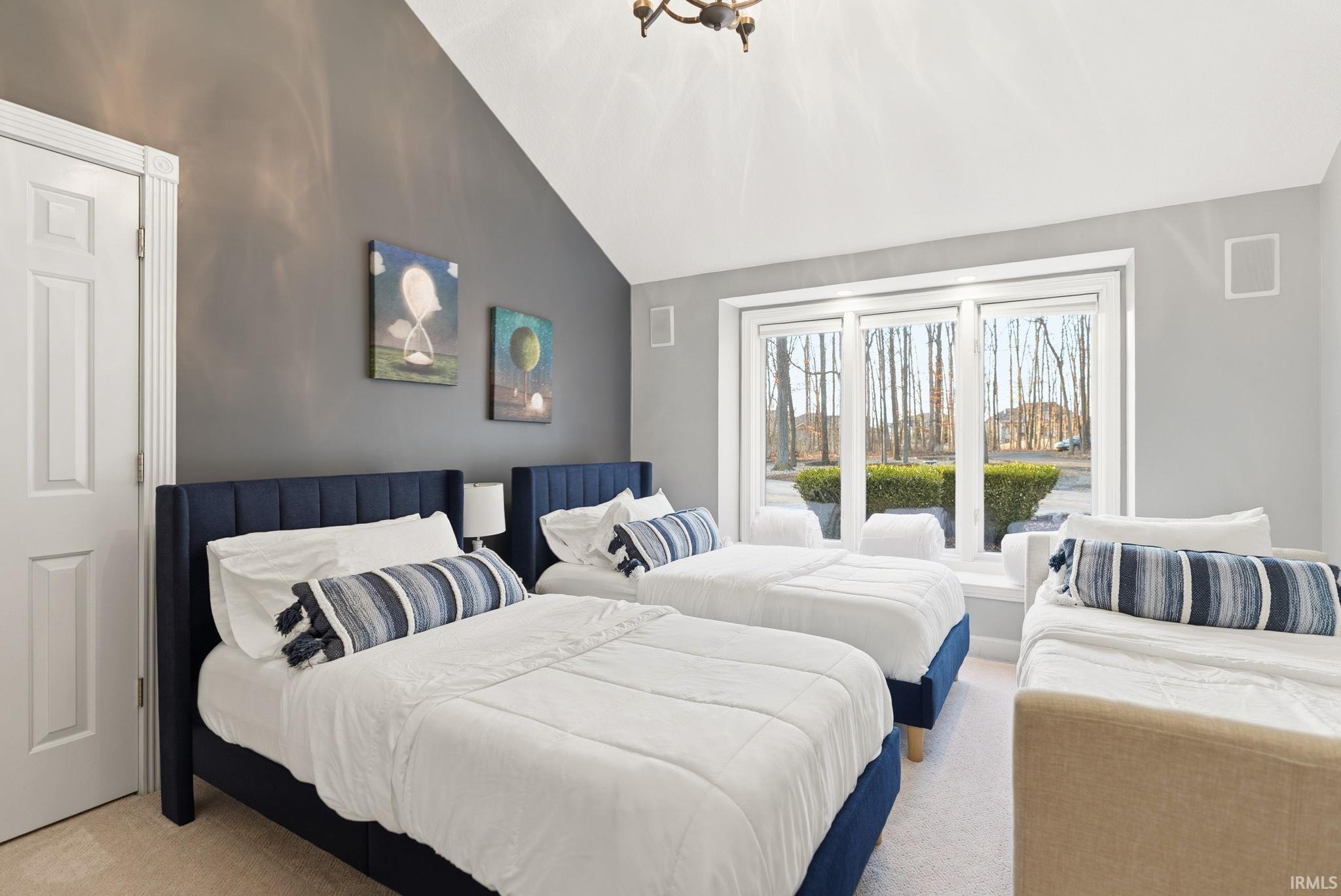 Carpeted bedroom with lofted ceiling