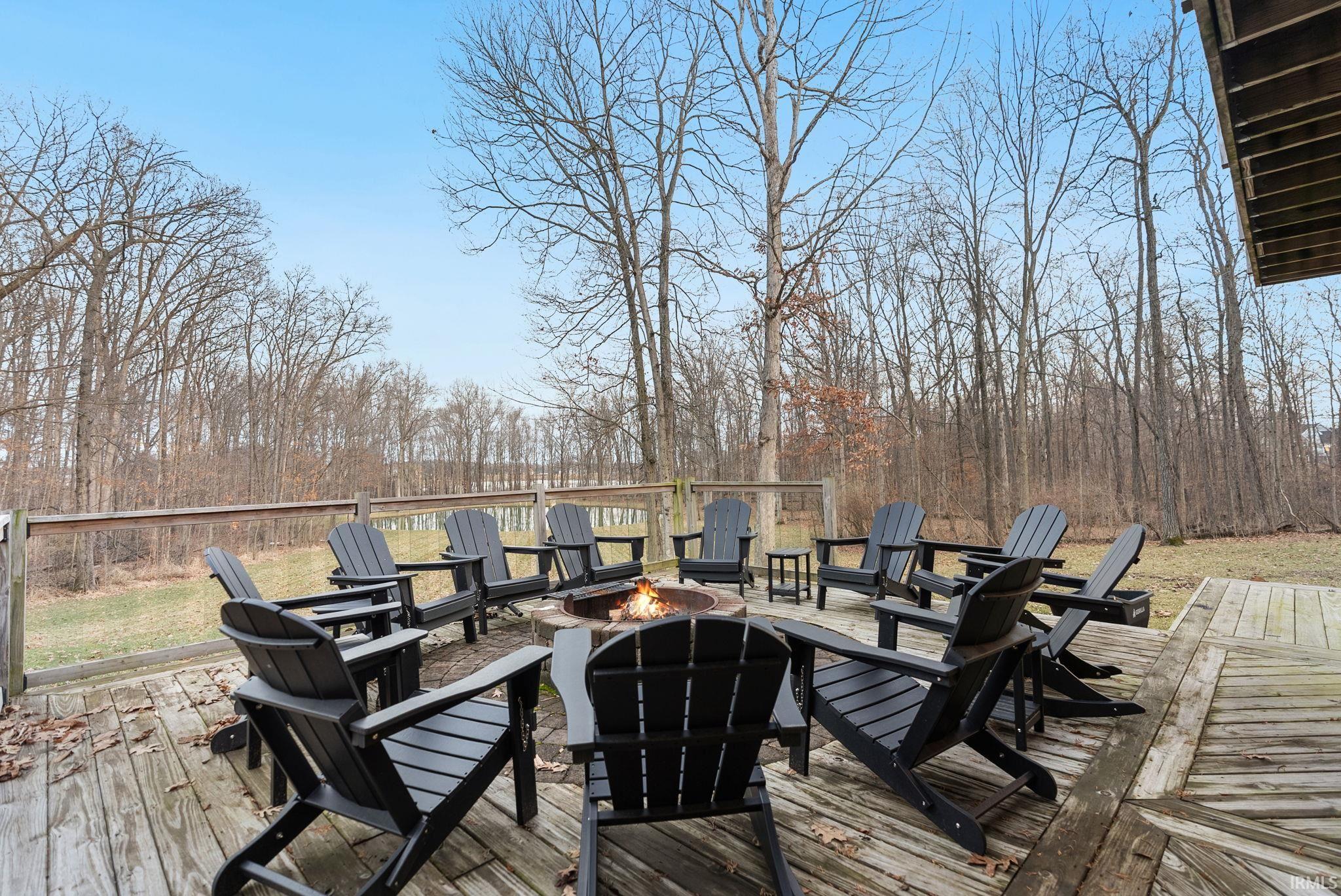 Wooden terrace featuring a fire pit