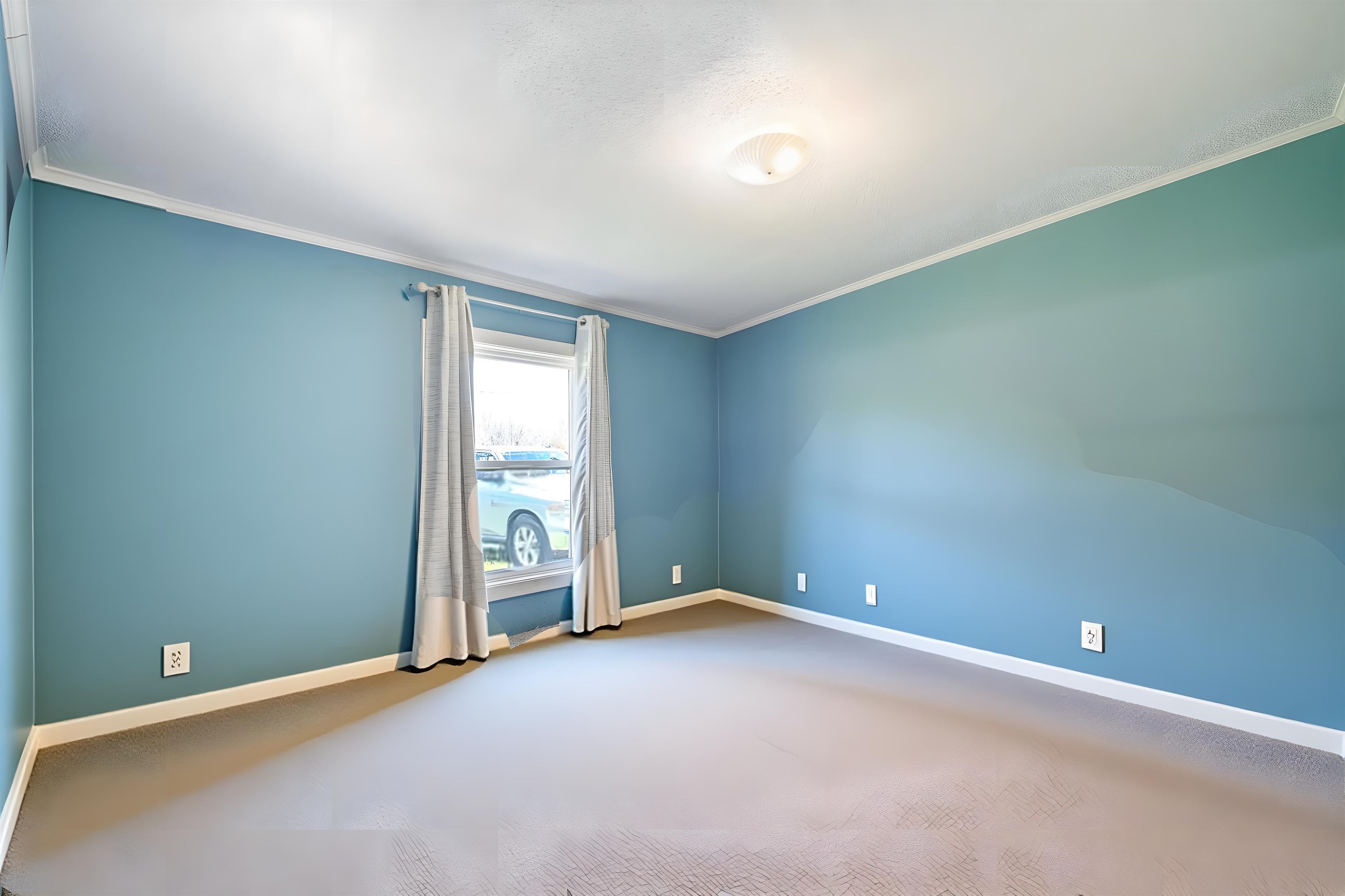 Empty room featuring light carpet and ornamental molding
