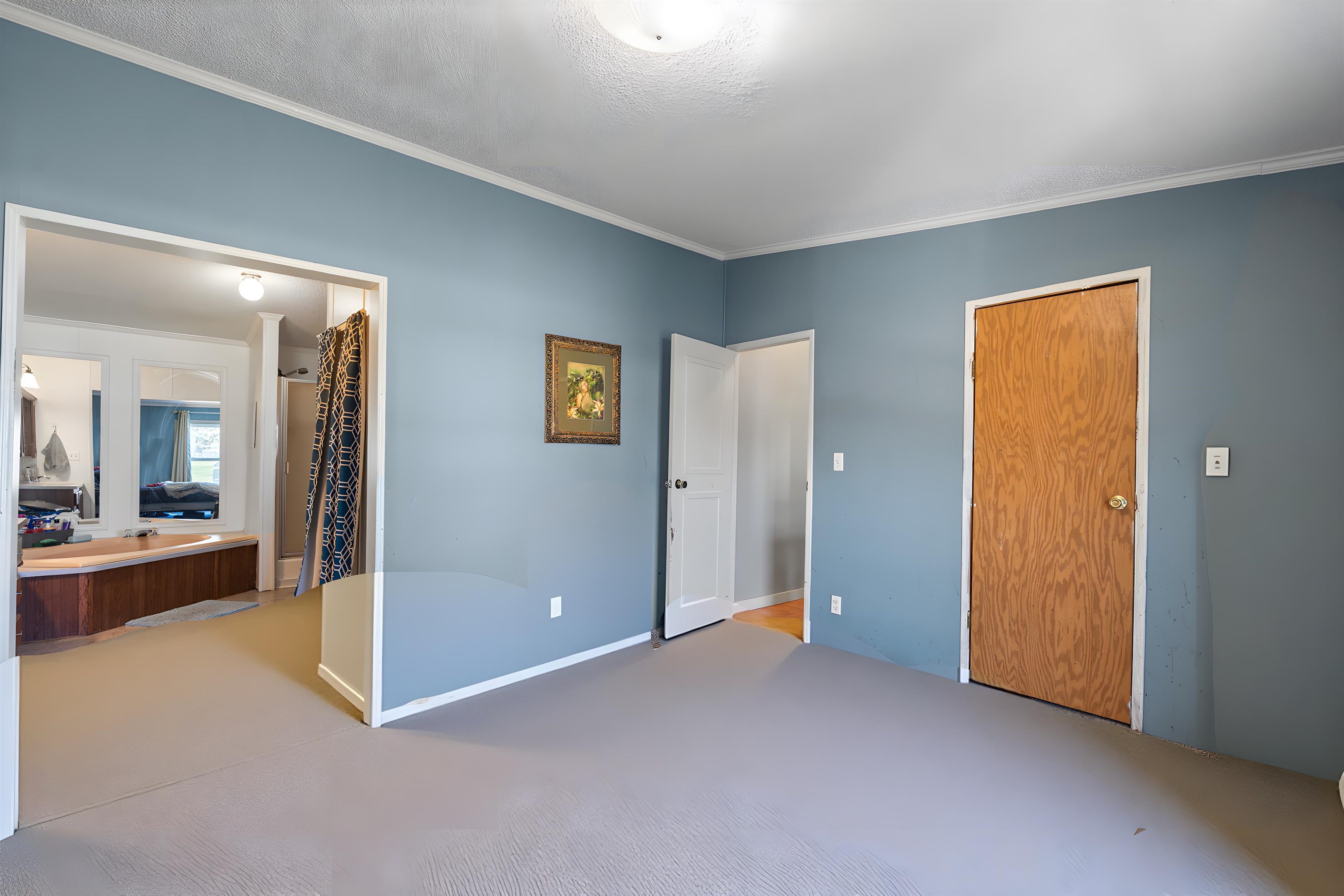 Unfurnished bedroom featuring light colored carpet and ornamental molding