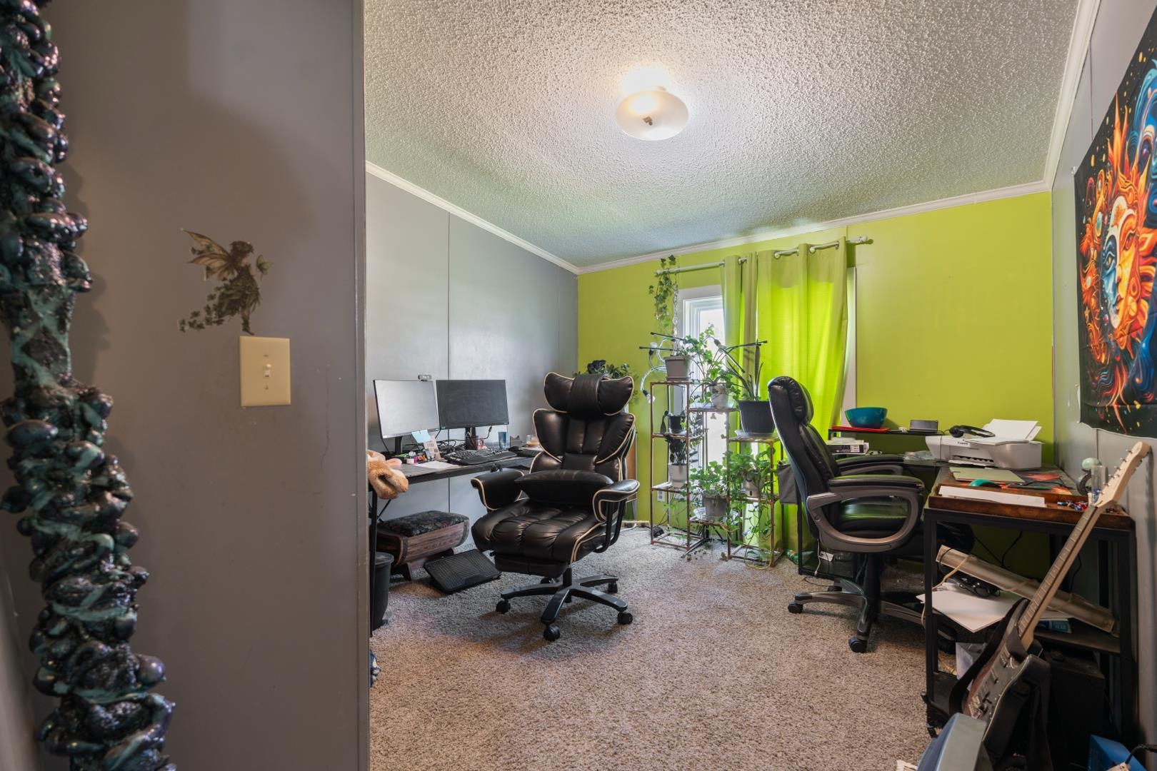 Office featuring a textured ceiling, light carpet, and ornamental molding