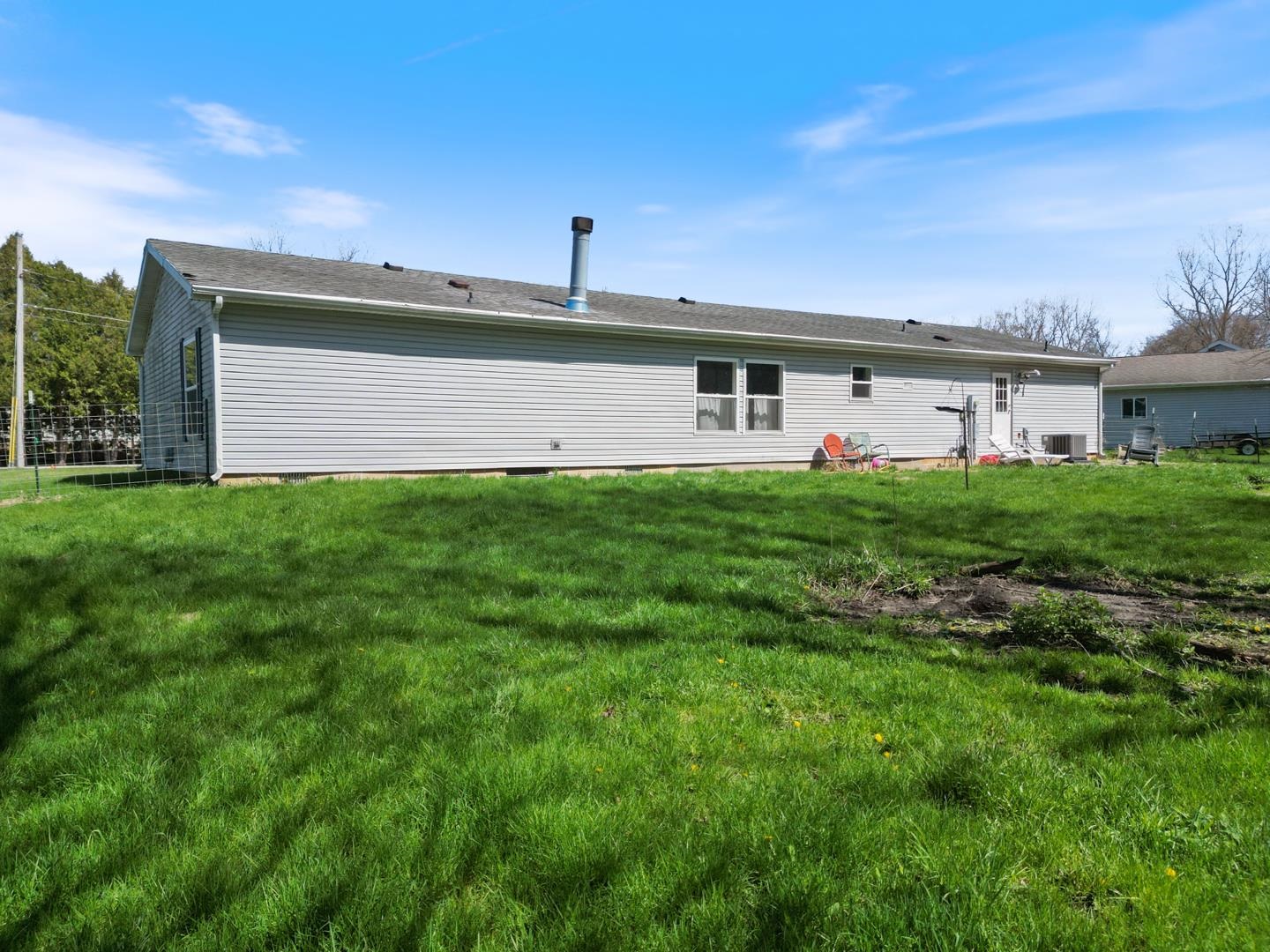 Back of house featuring a lawn