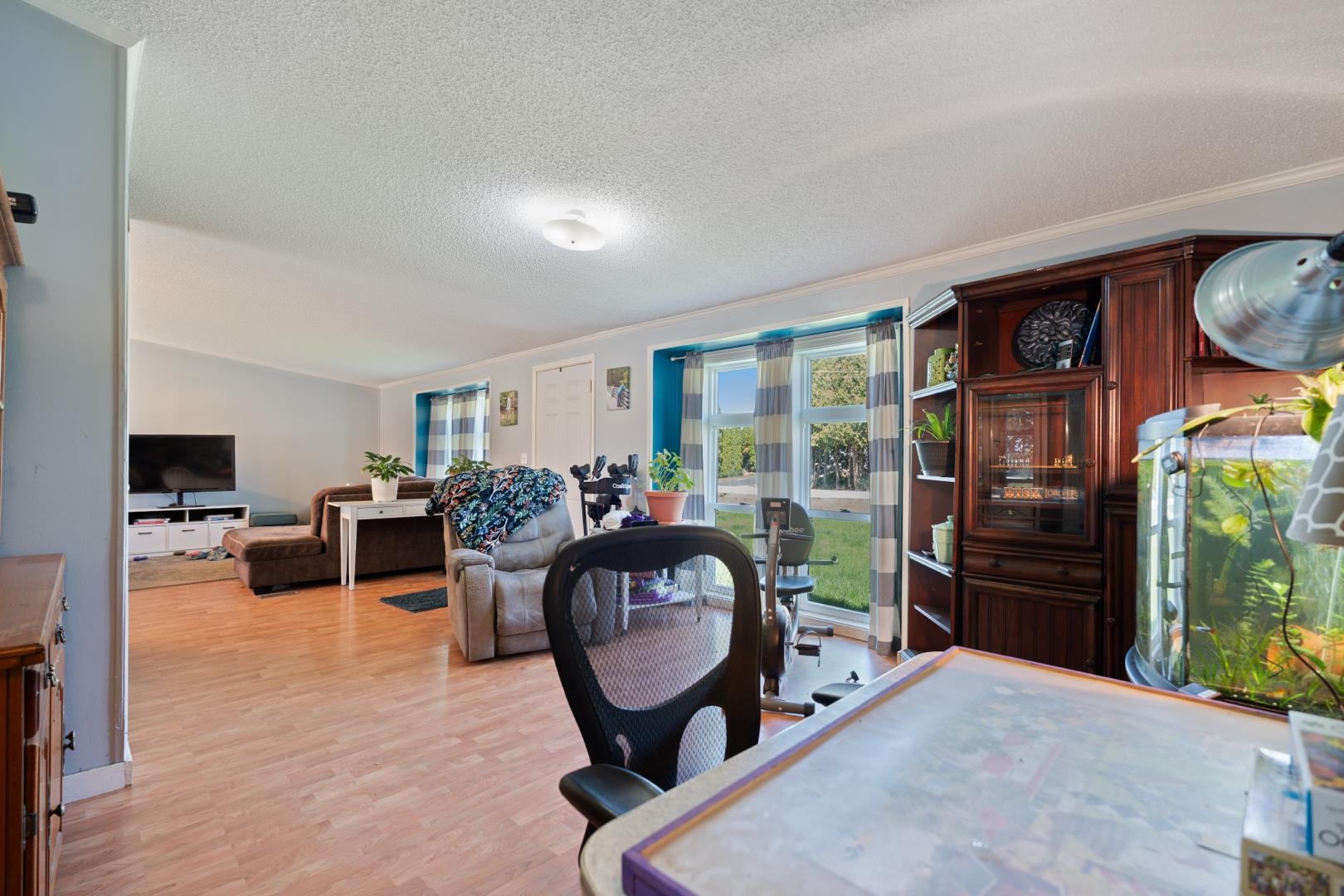Dining area with light wood-style flooring and crown molding