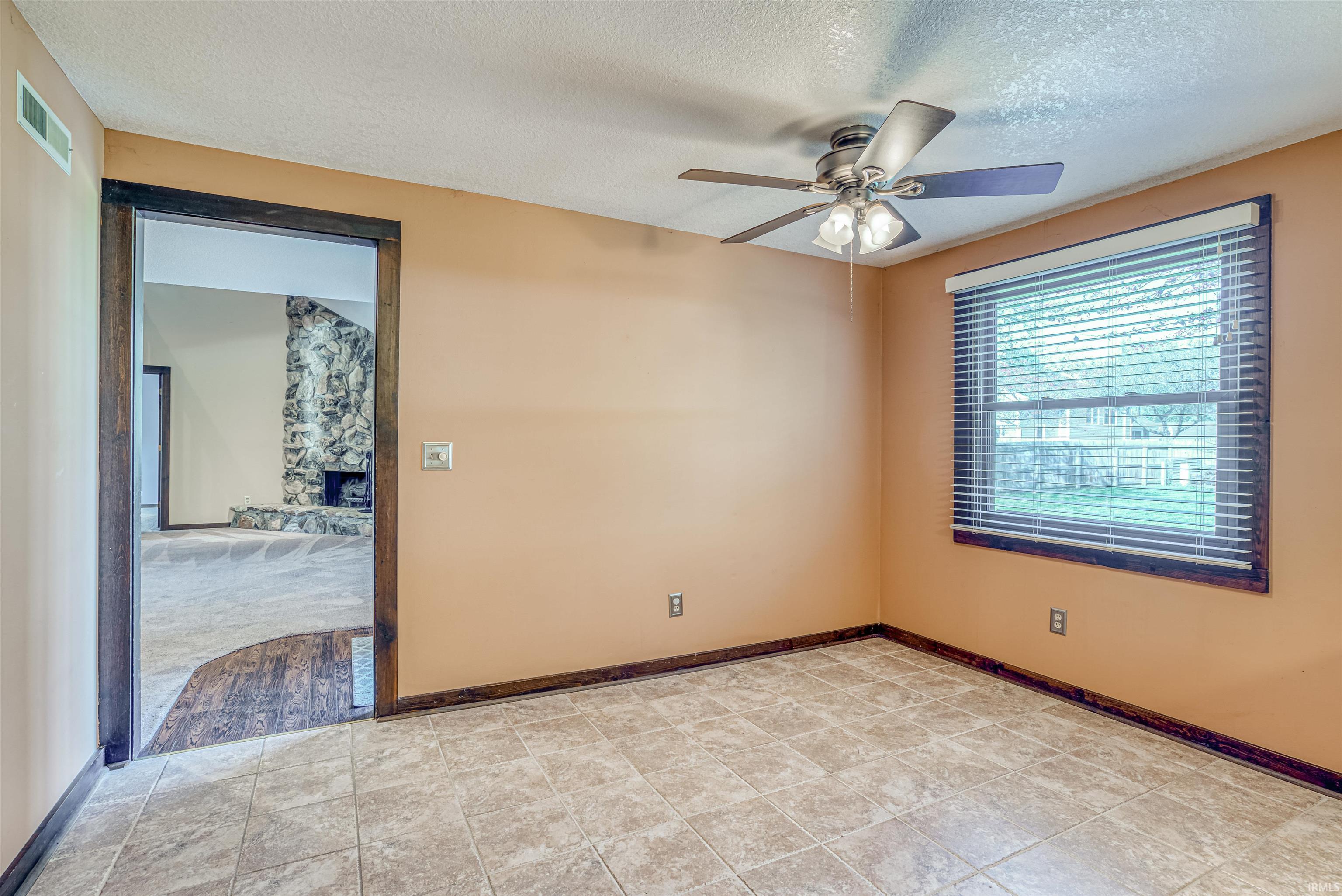 Unfurnished room featuring a textured ceiling and a ceiling fan