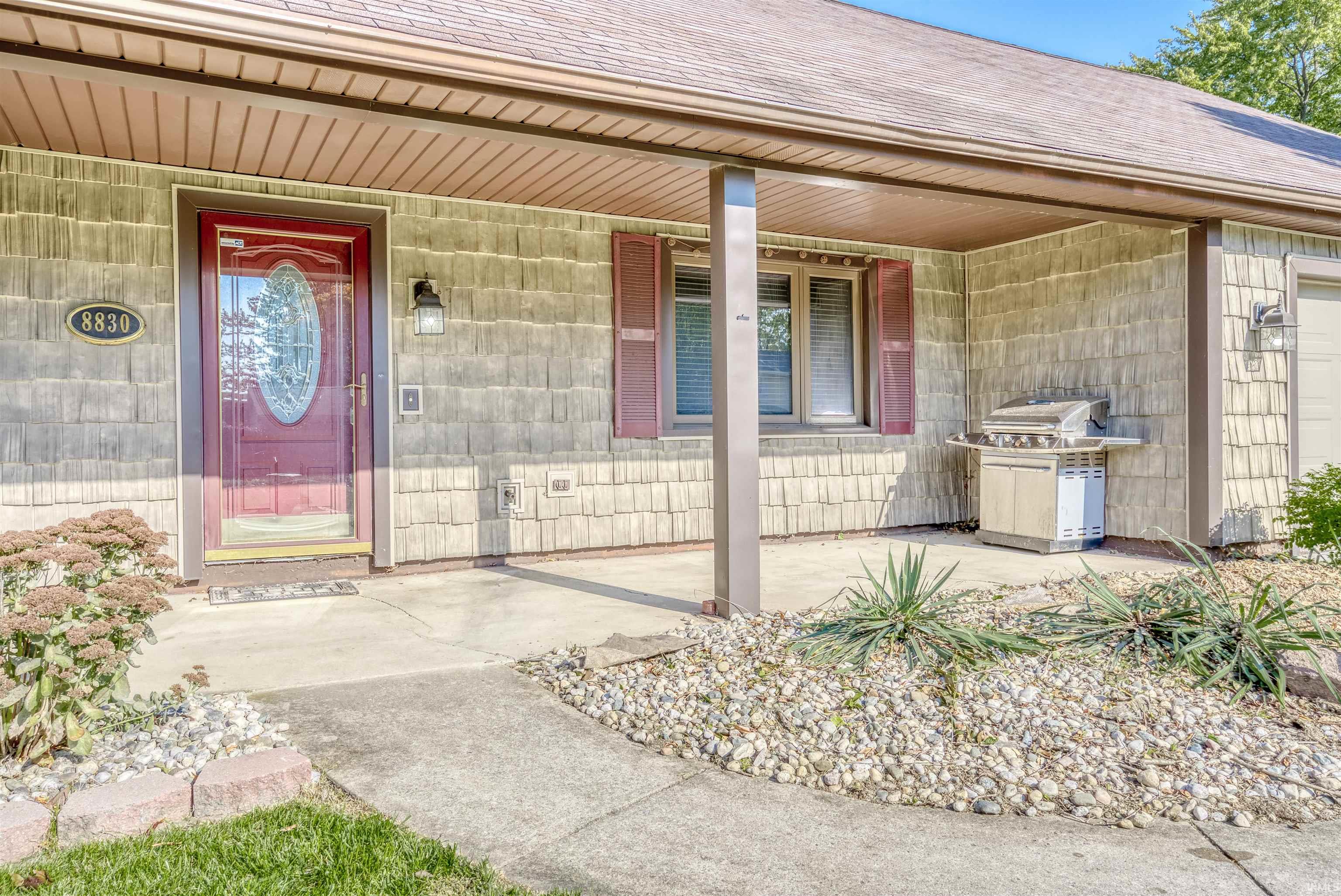 View of exterior entry with covered porch