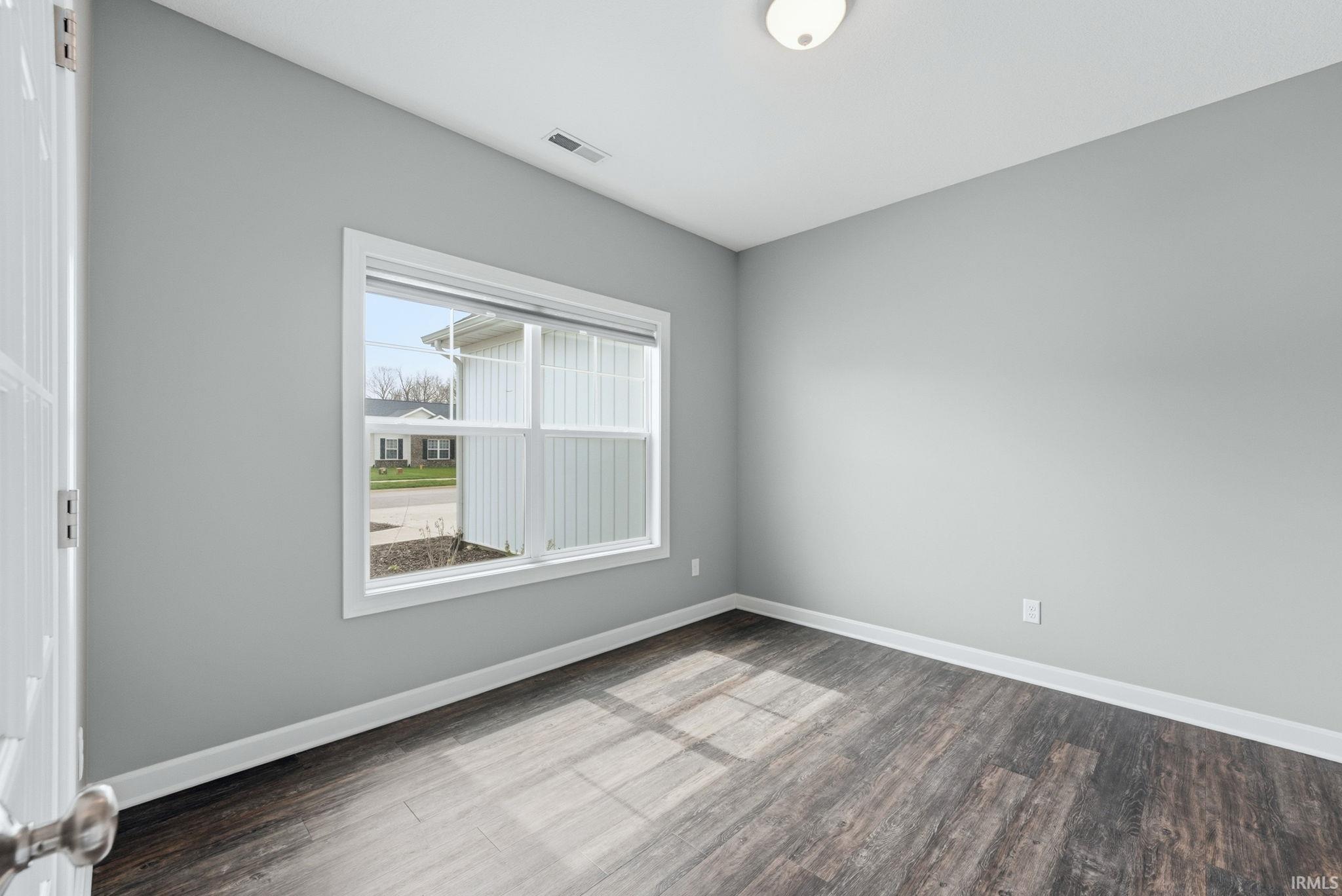 Unfurnished room featuring baseboards and light wood-type flooring