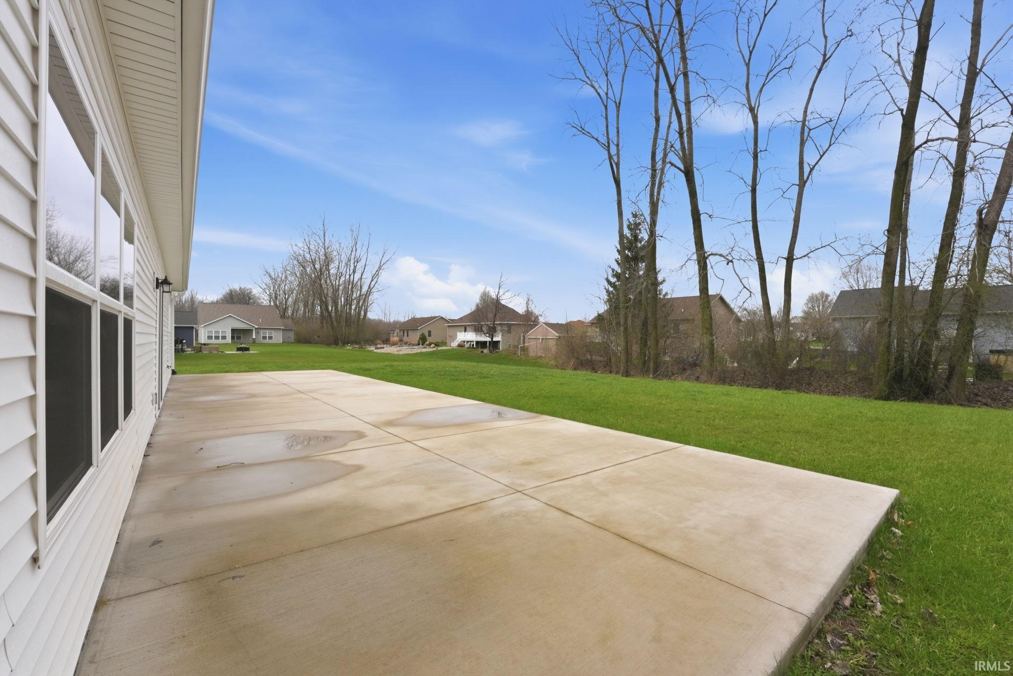 View of front of home with brick siding, an attached garage, roof with shingles, and driveway