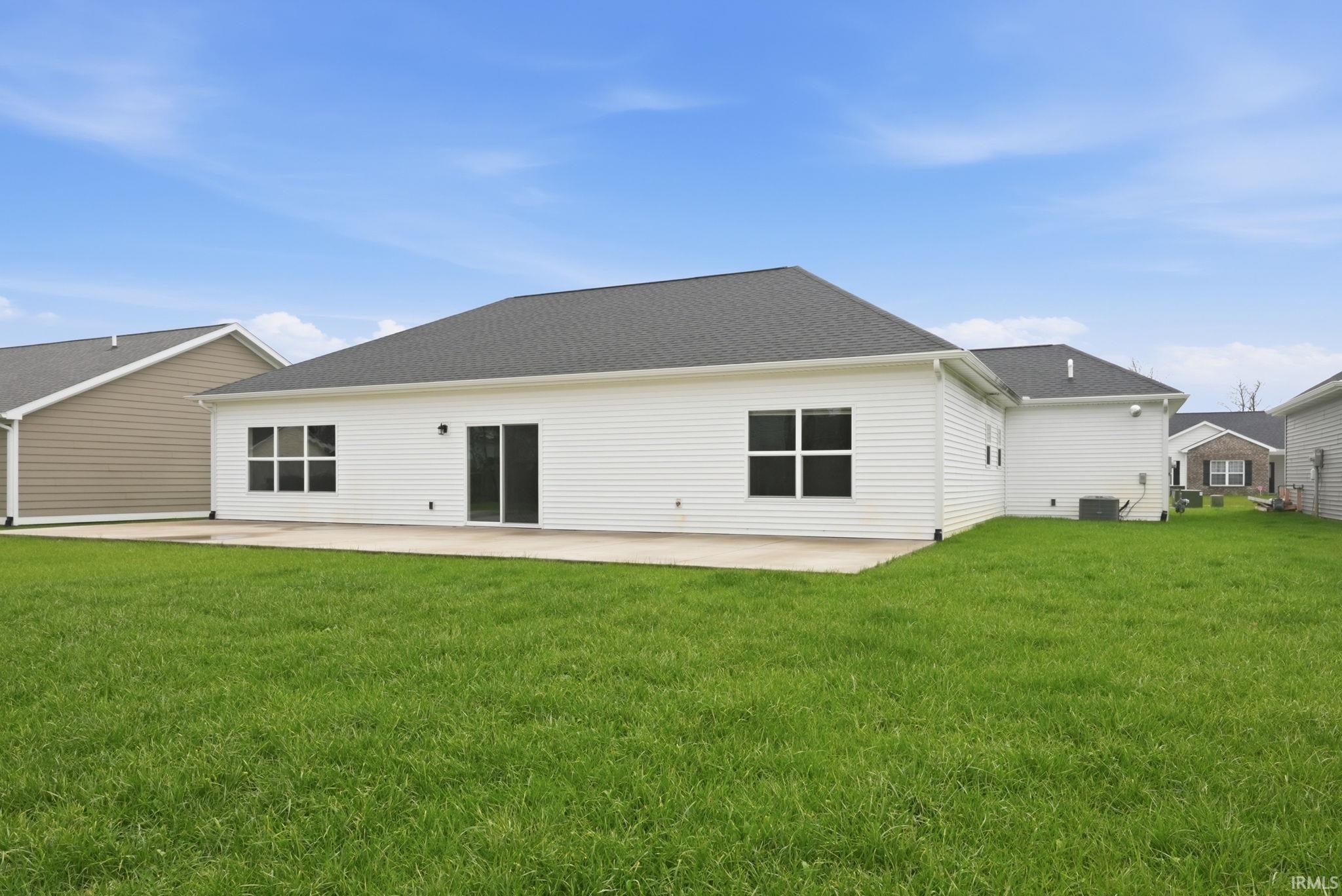 View of front of house featuring concrete driveway, a garage, brick siding, and a front yard