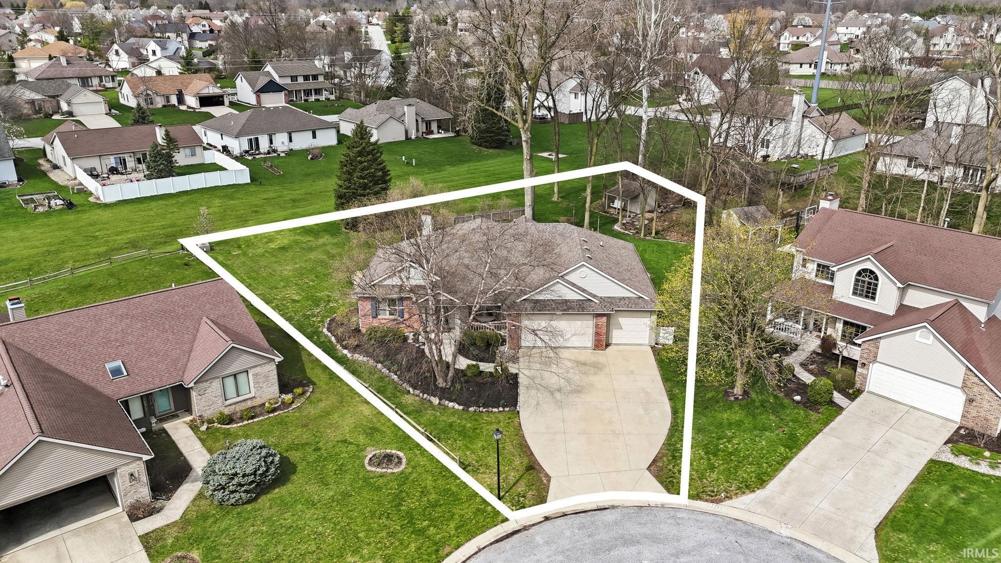 Aerial view of residential area featuring property boundaries highlighted