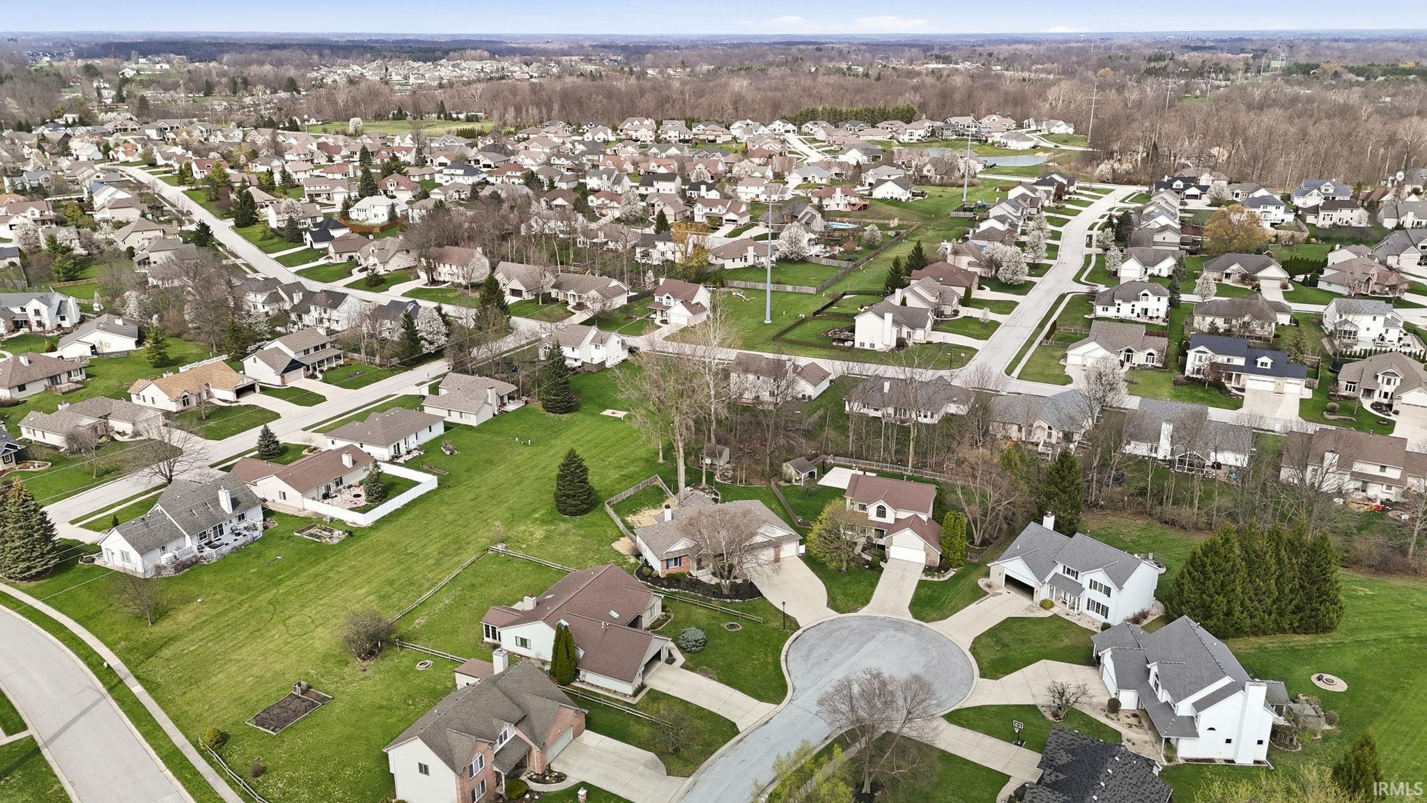 Aerial view of property's location with nearby suburban area