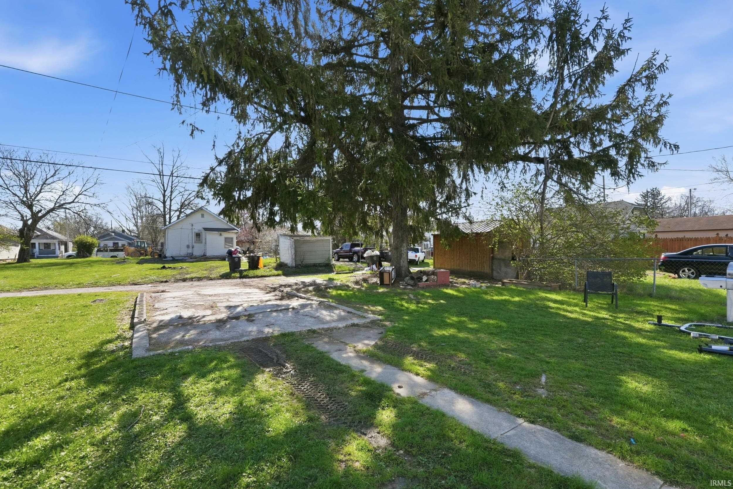 View of yard featuring a residential view and an outbuilding