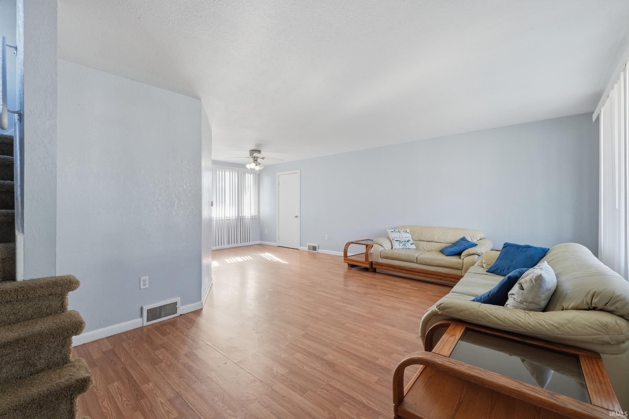 Living area featuring wood finished floors and ceiling fan