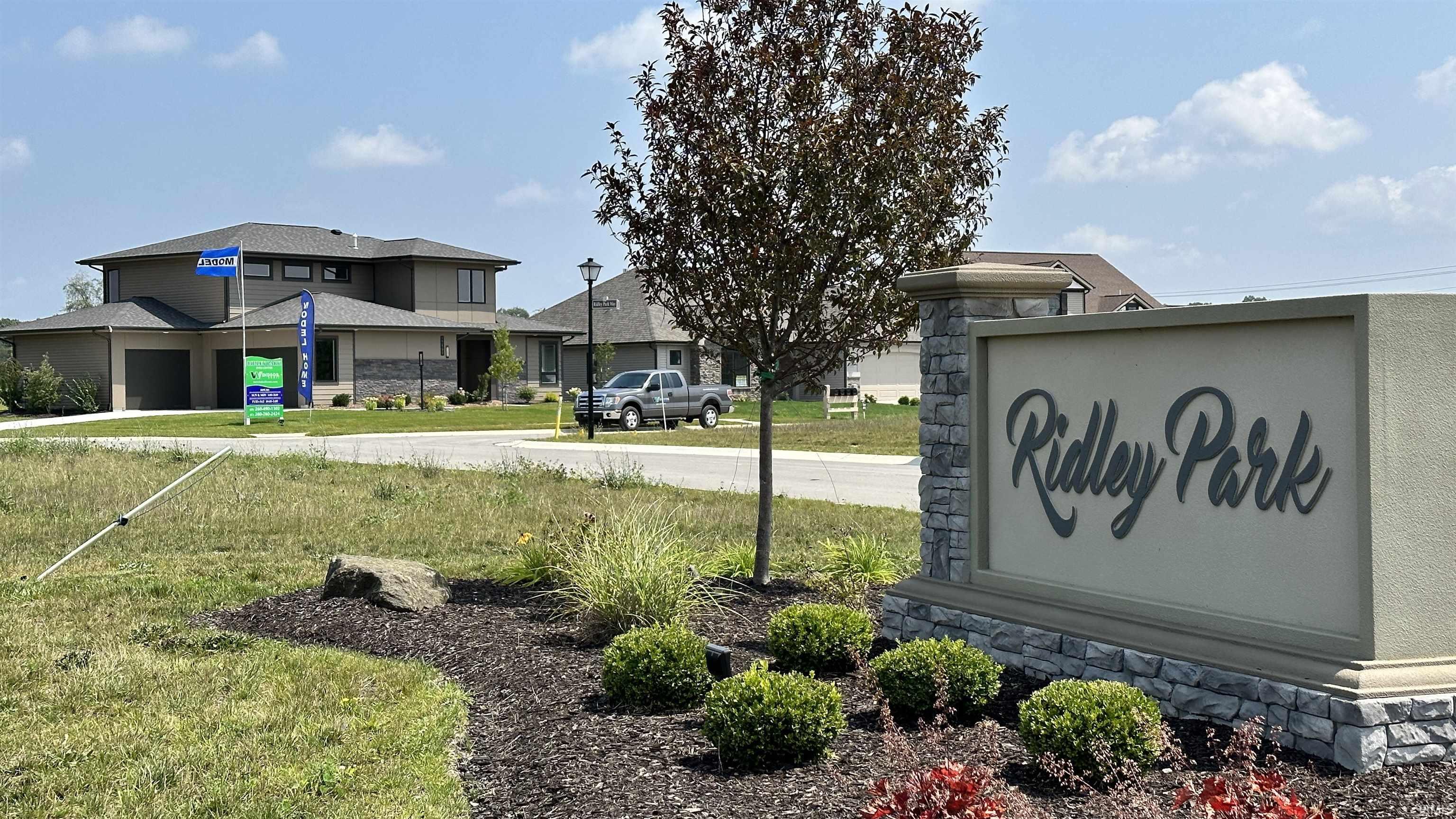 Community / neighborhood sign with a yard