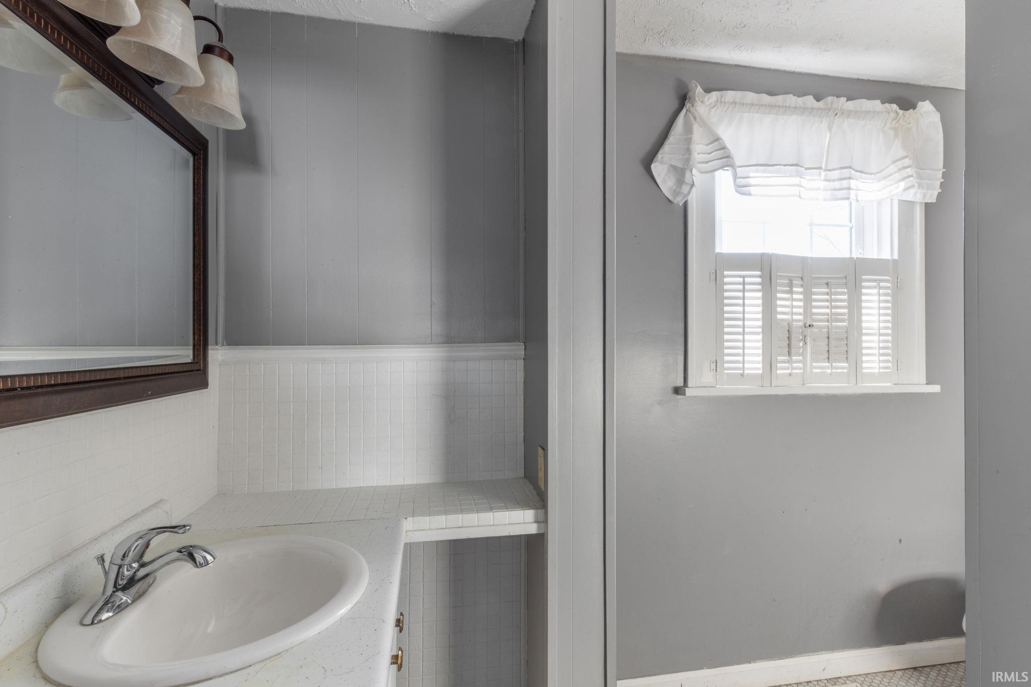 Bathroom with vanity and baseboards