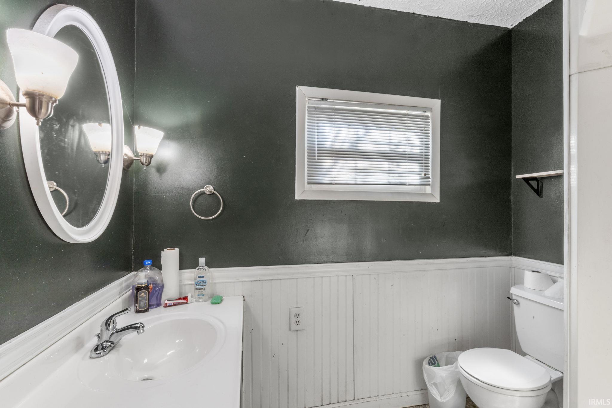 Bathroom featuring a wainscoted wall and vanity