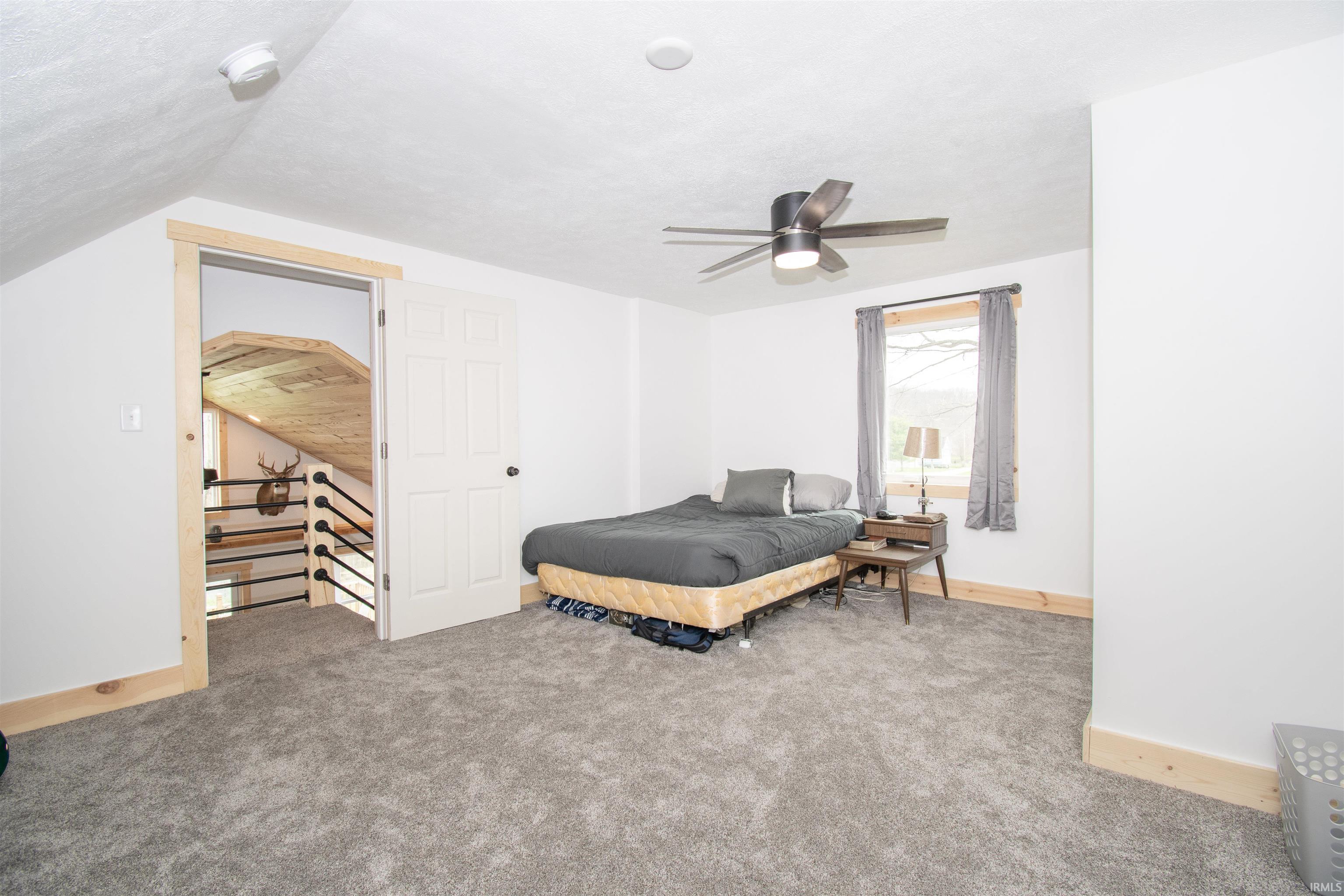 Bedroom featuring light colored carpet and a ceiling fan