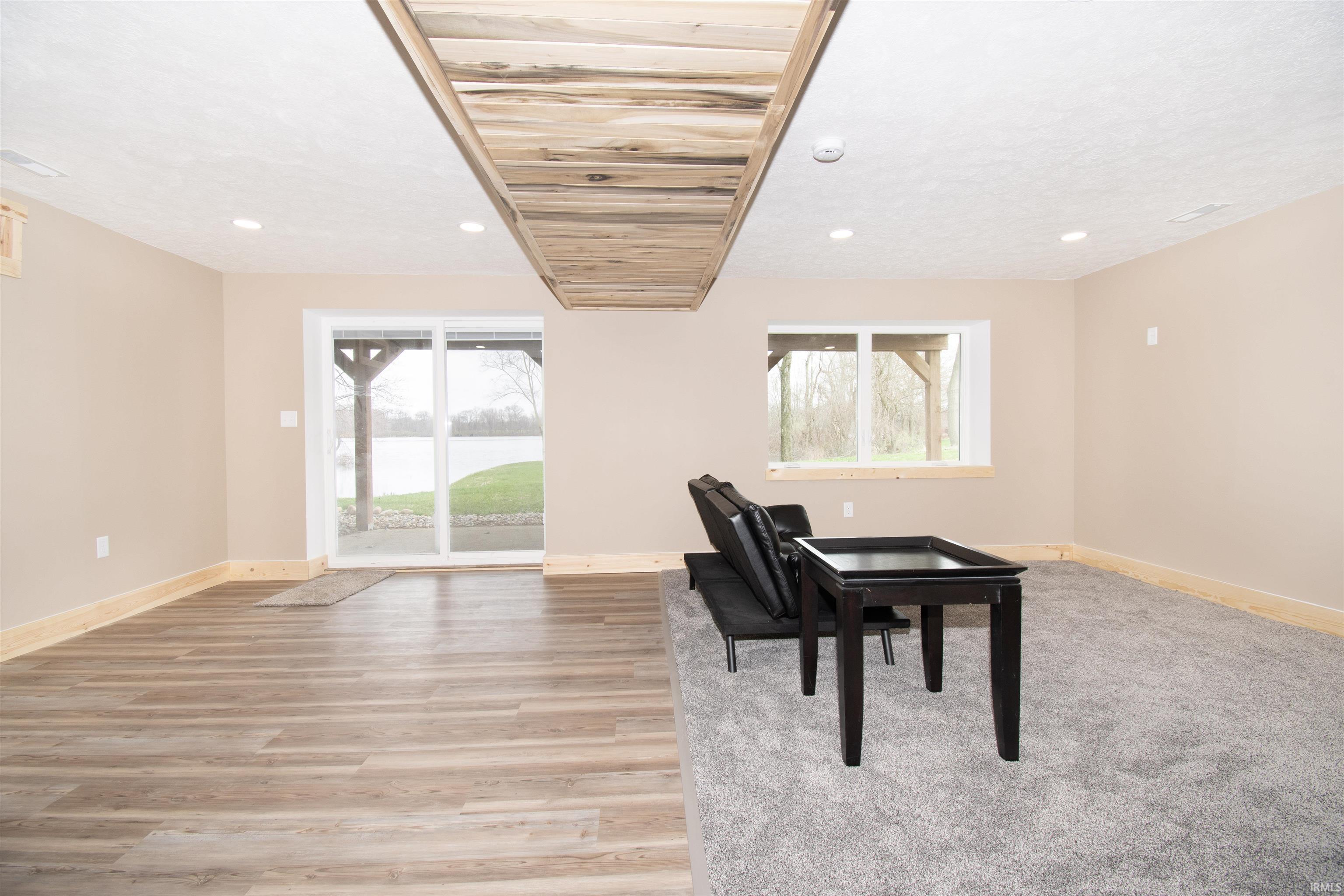 Living area with plenty of natural light, light wood-type flooring, and recessed lighting