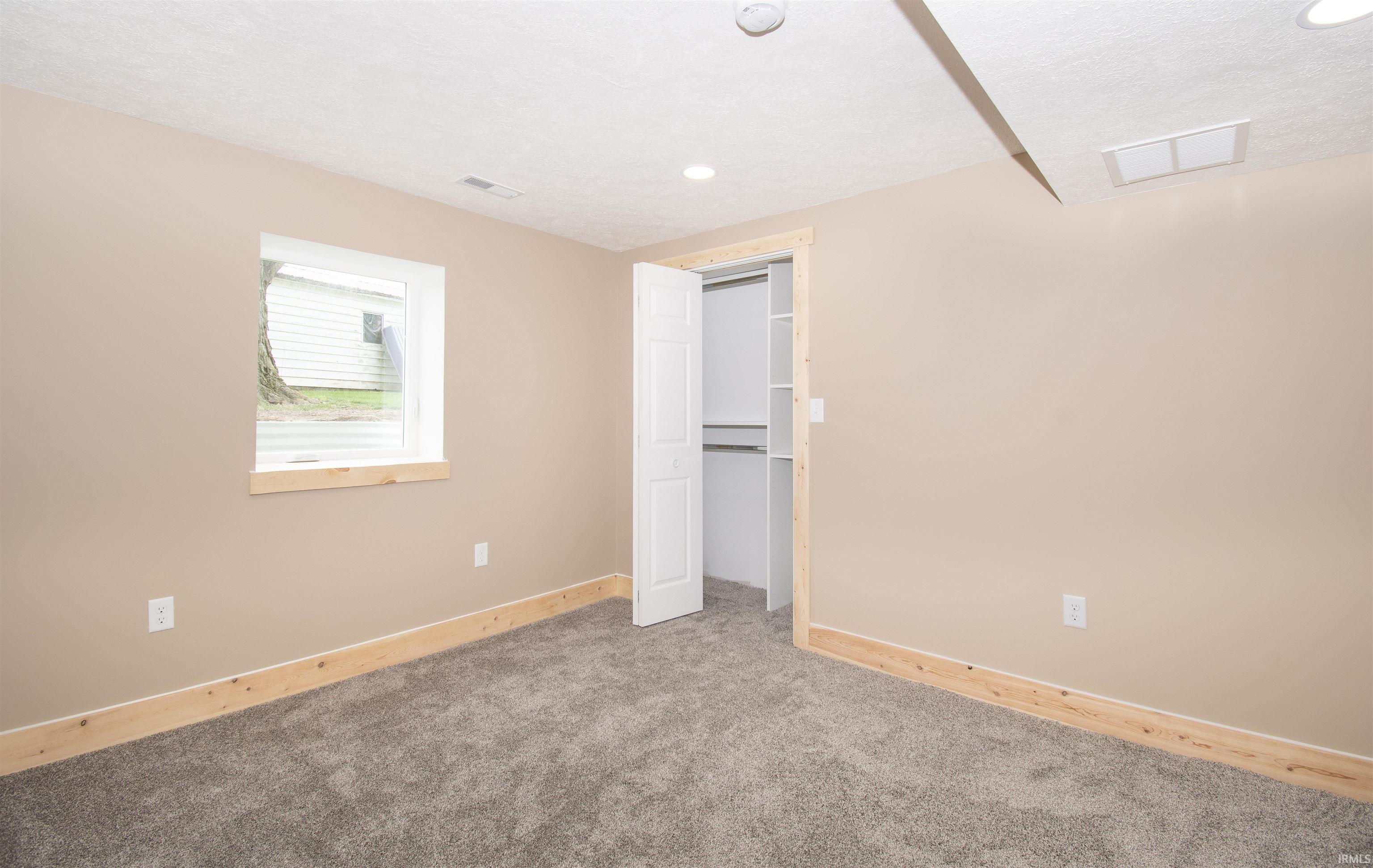 Unfurnished bedroom with carpet and a closet
