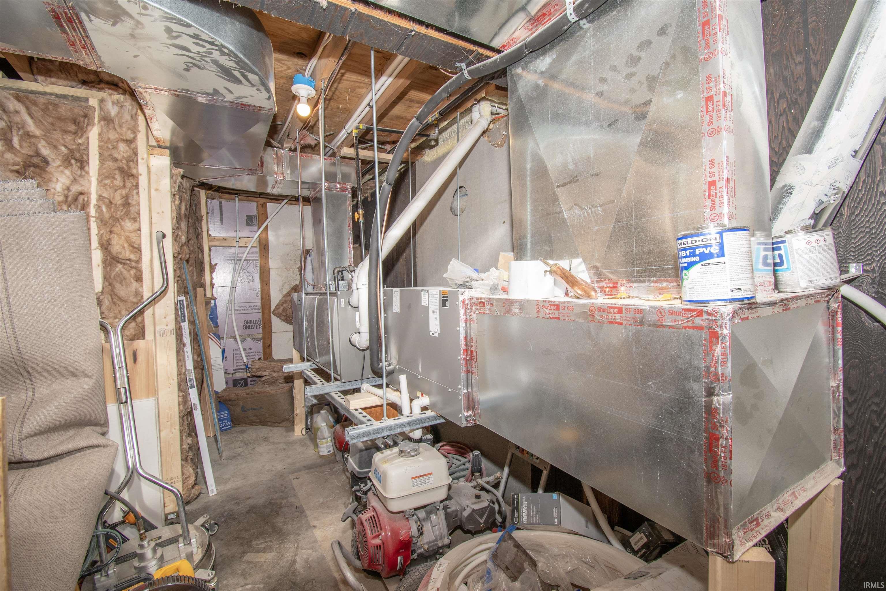 Unfinished below grade area with heating unit