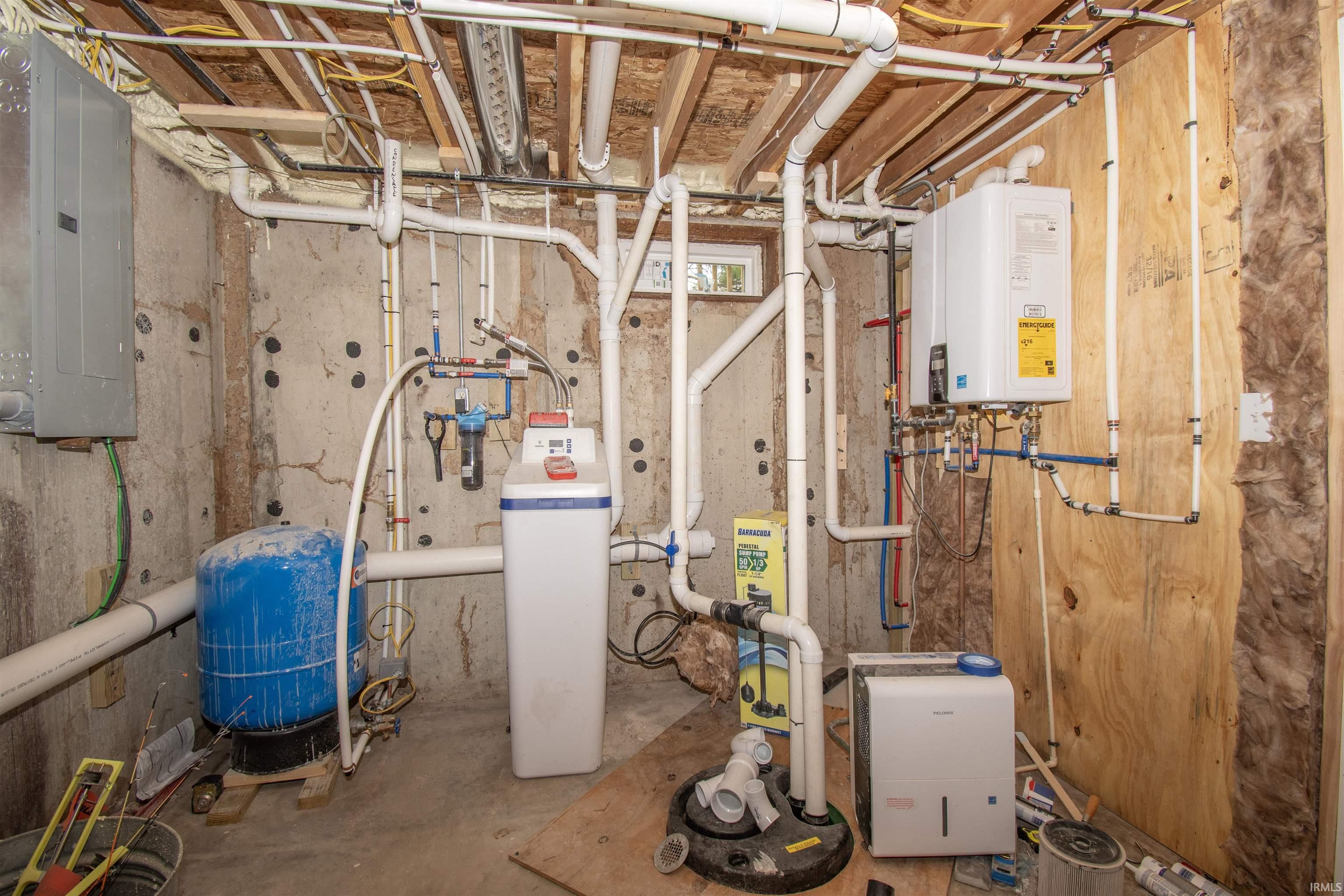 Utility room featuring water heater and electric panel