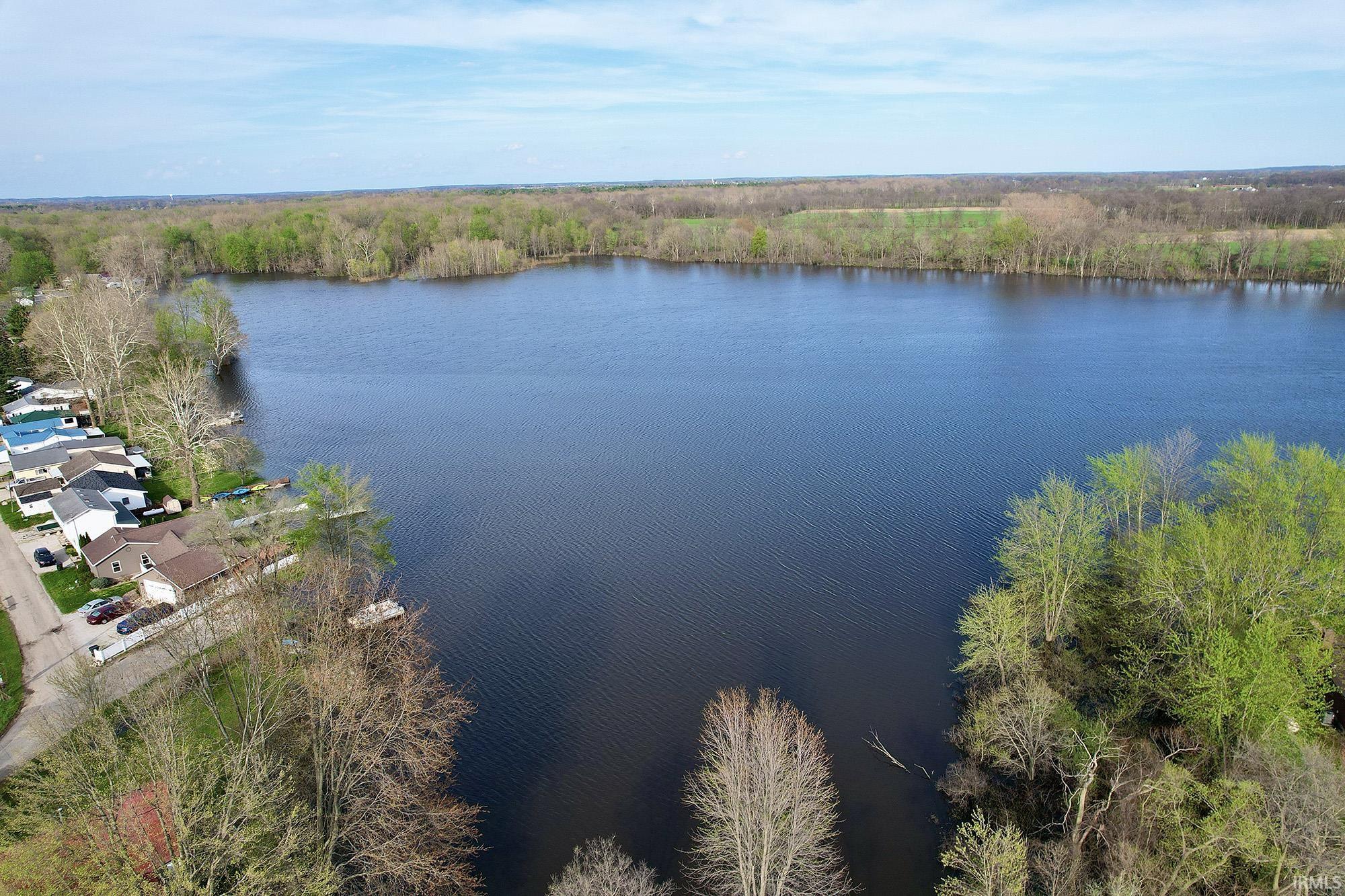 Water view with a heavily wooded area