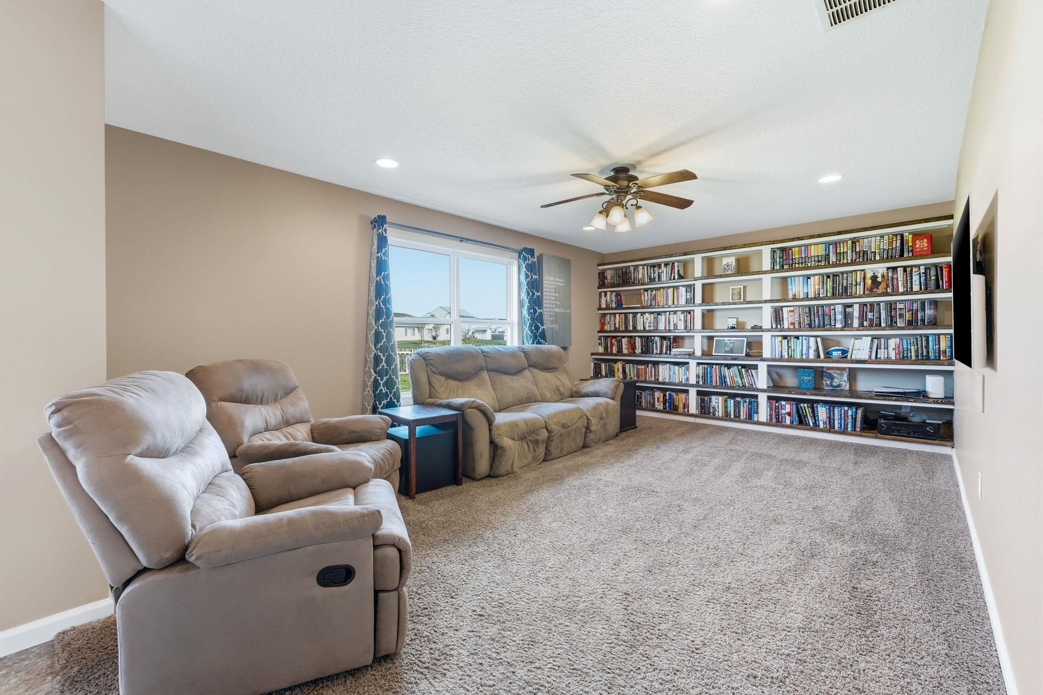 Living area featuring a ceiling fan, carpet floors, and recessed lighting