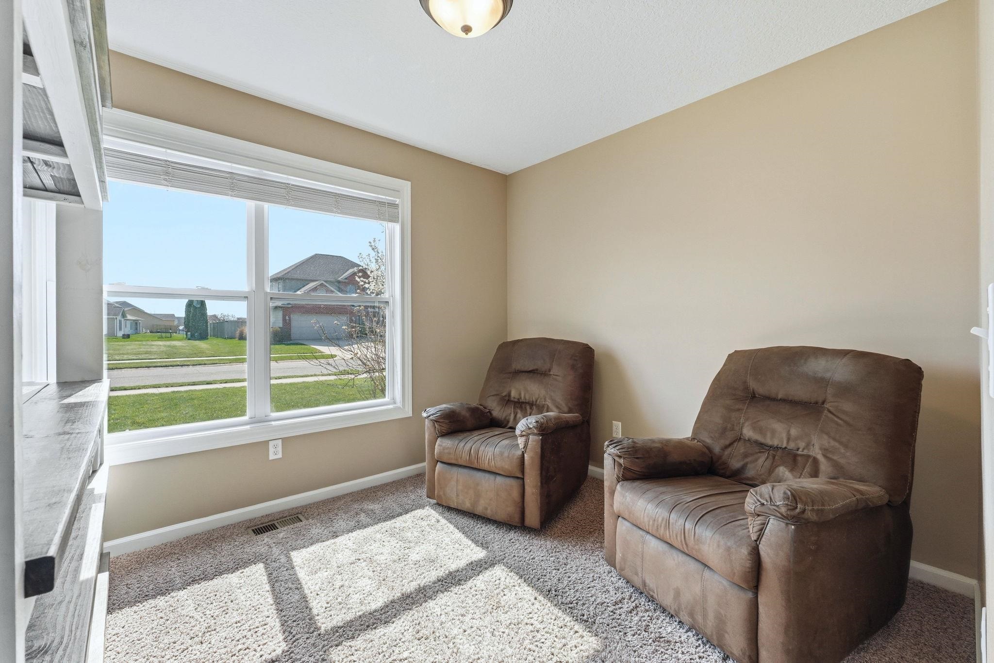 Sitting room featuring light carpet and baseboards