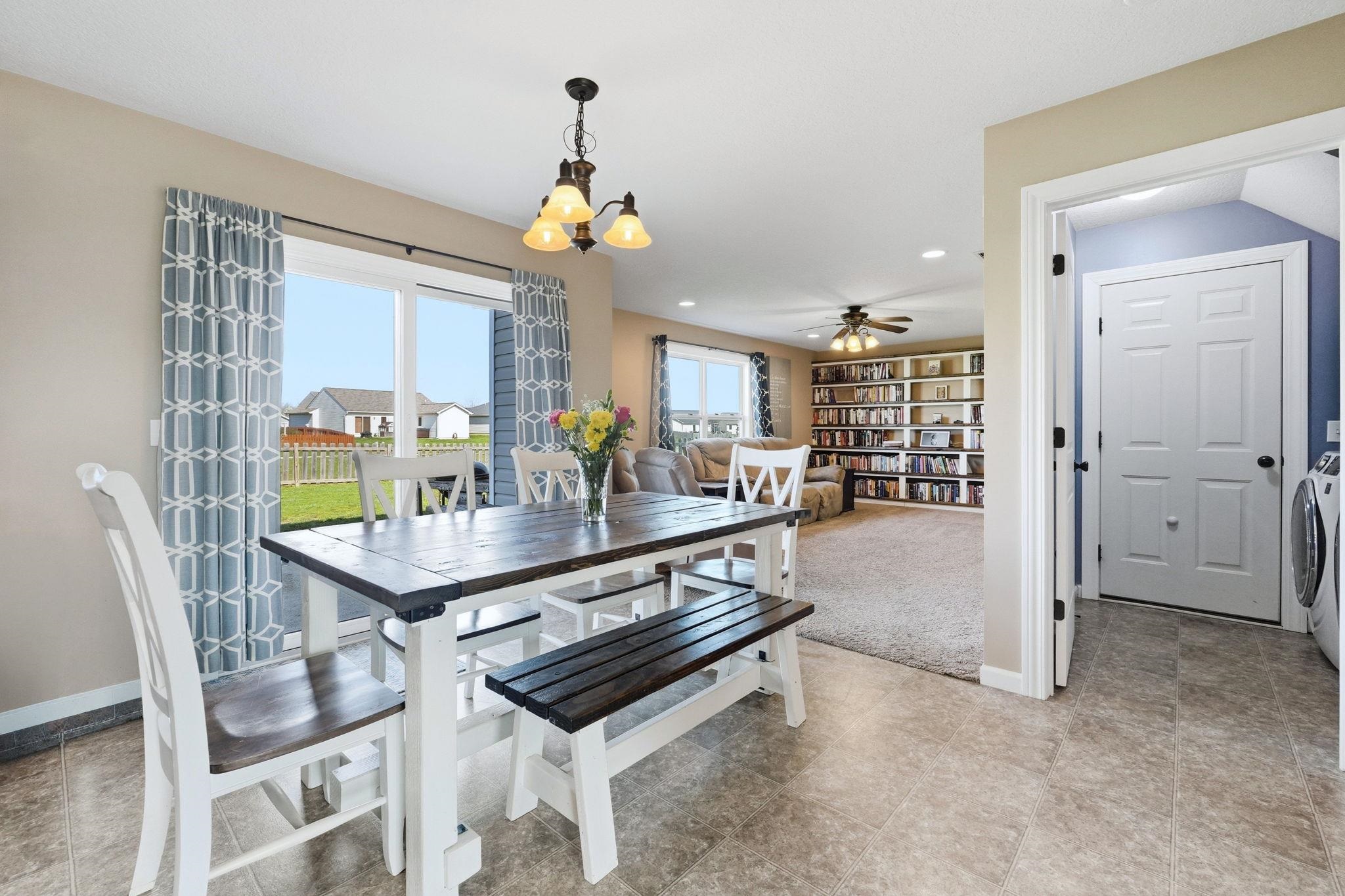 Dining space with suspended lighting and ceiling fan