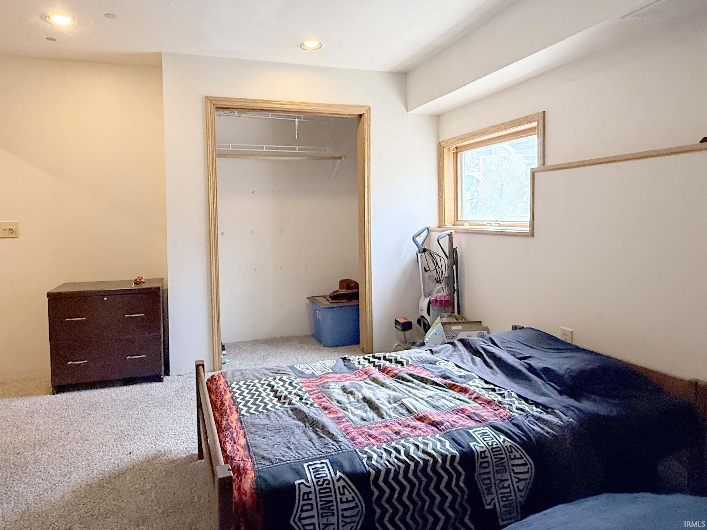 Bedroom with carpet floors, recessed lighting, and a closet