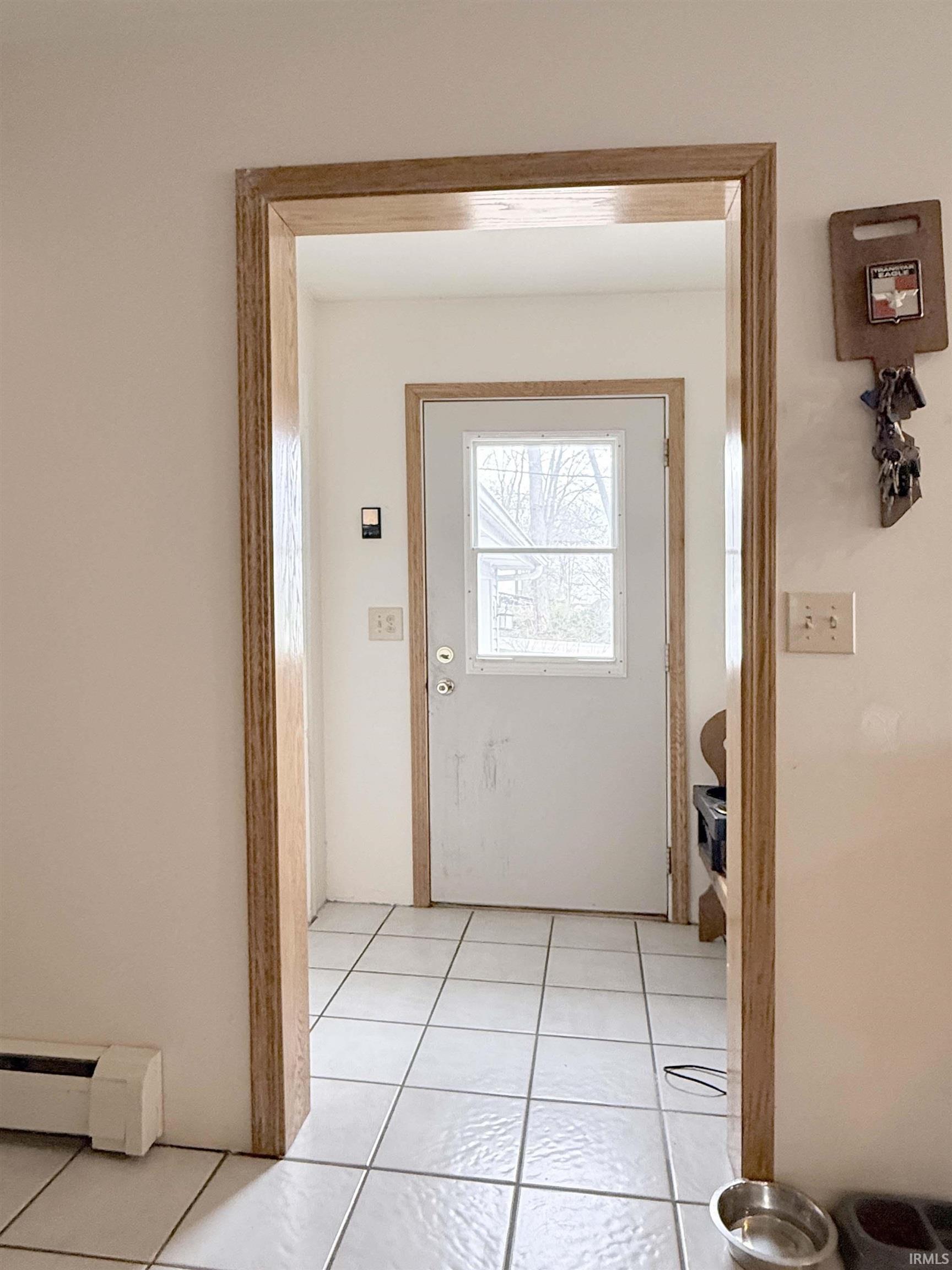 Entryway featuring baseboard heating and tile patterned floors