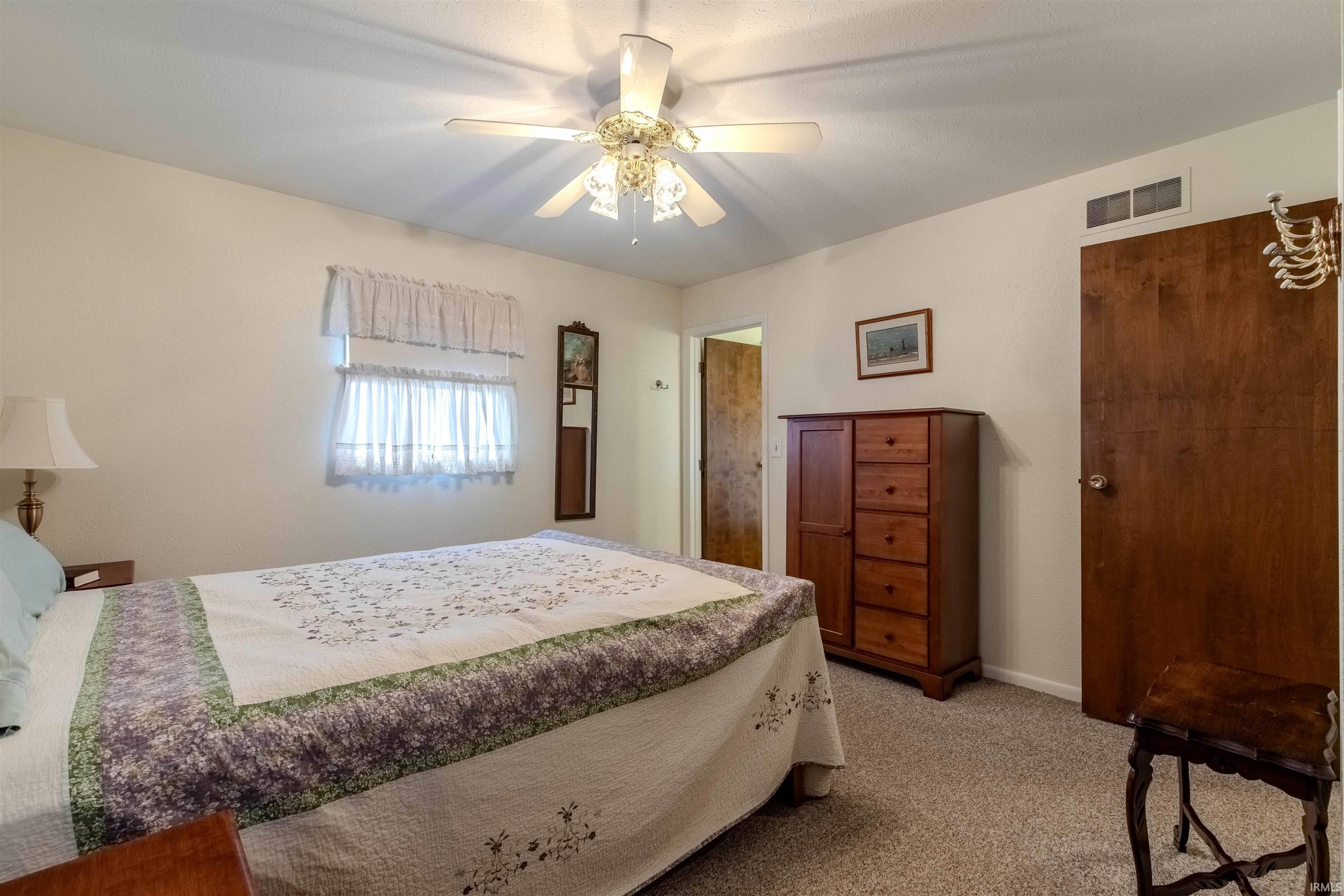 Bedroom featuring ceiling fan and light colored carpet