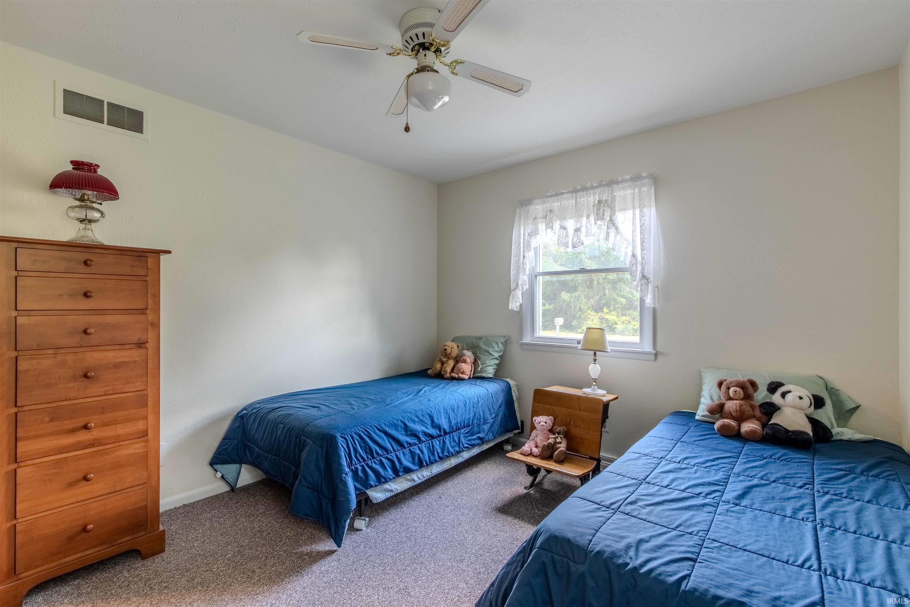 Bedroom with carpet and ceiling fan