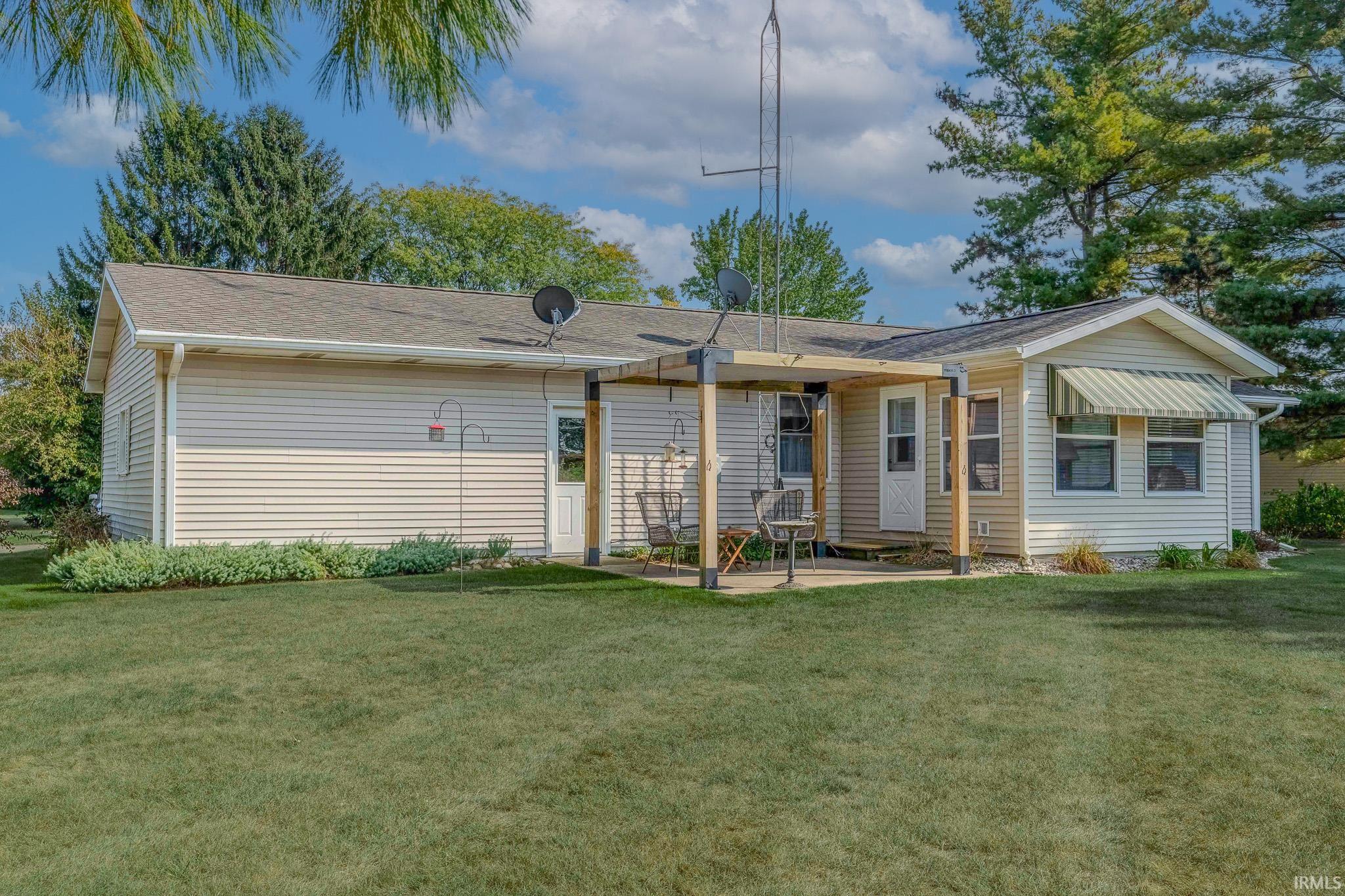 Back of house with a lawn