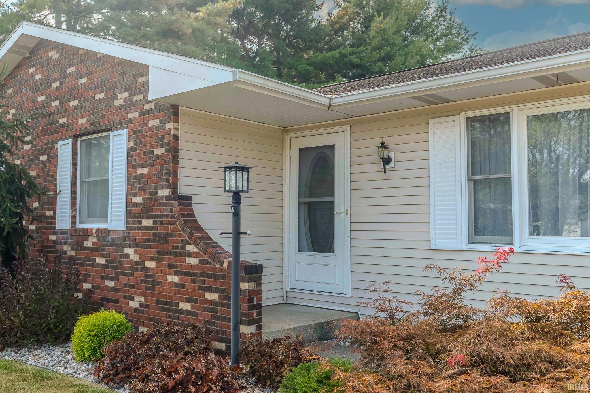 Entrance to property with brick siding