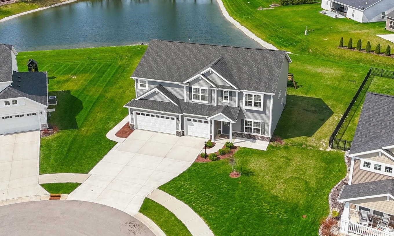 Aerial view of residential area featuring a large body of water