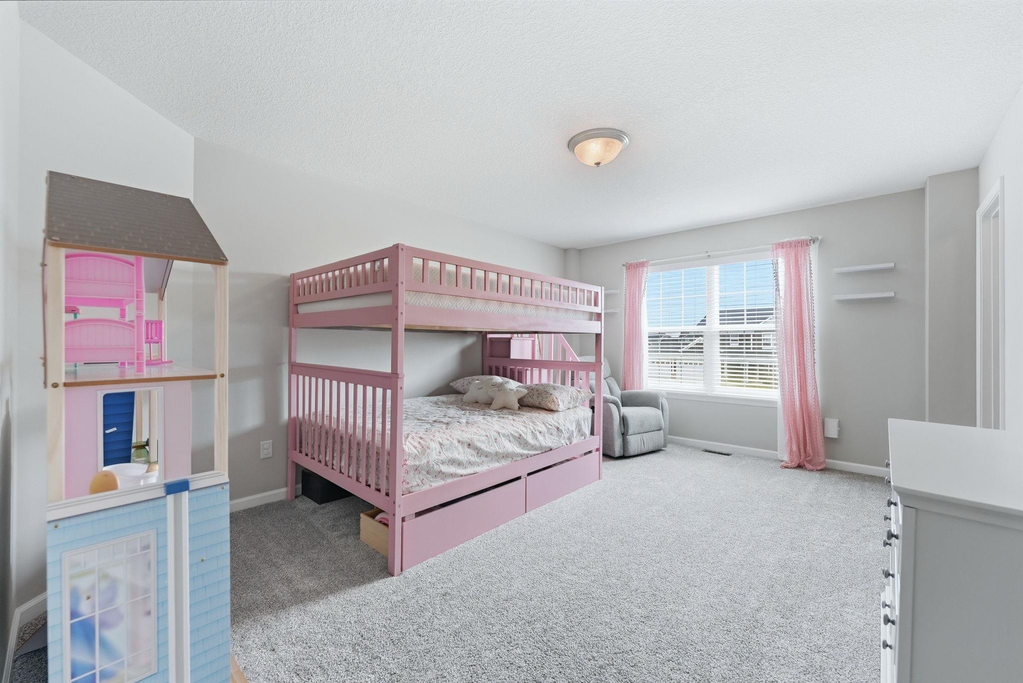 Bedroom featuring light colored carpet and baseboards