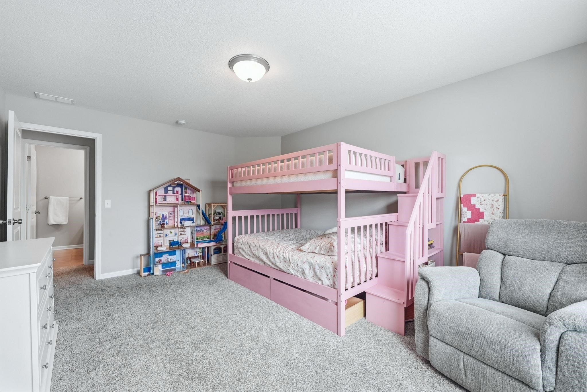 Bedroom with light carpet and baseboards