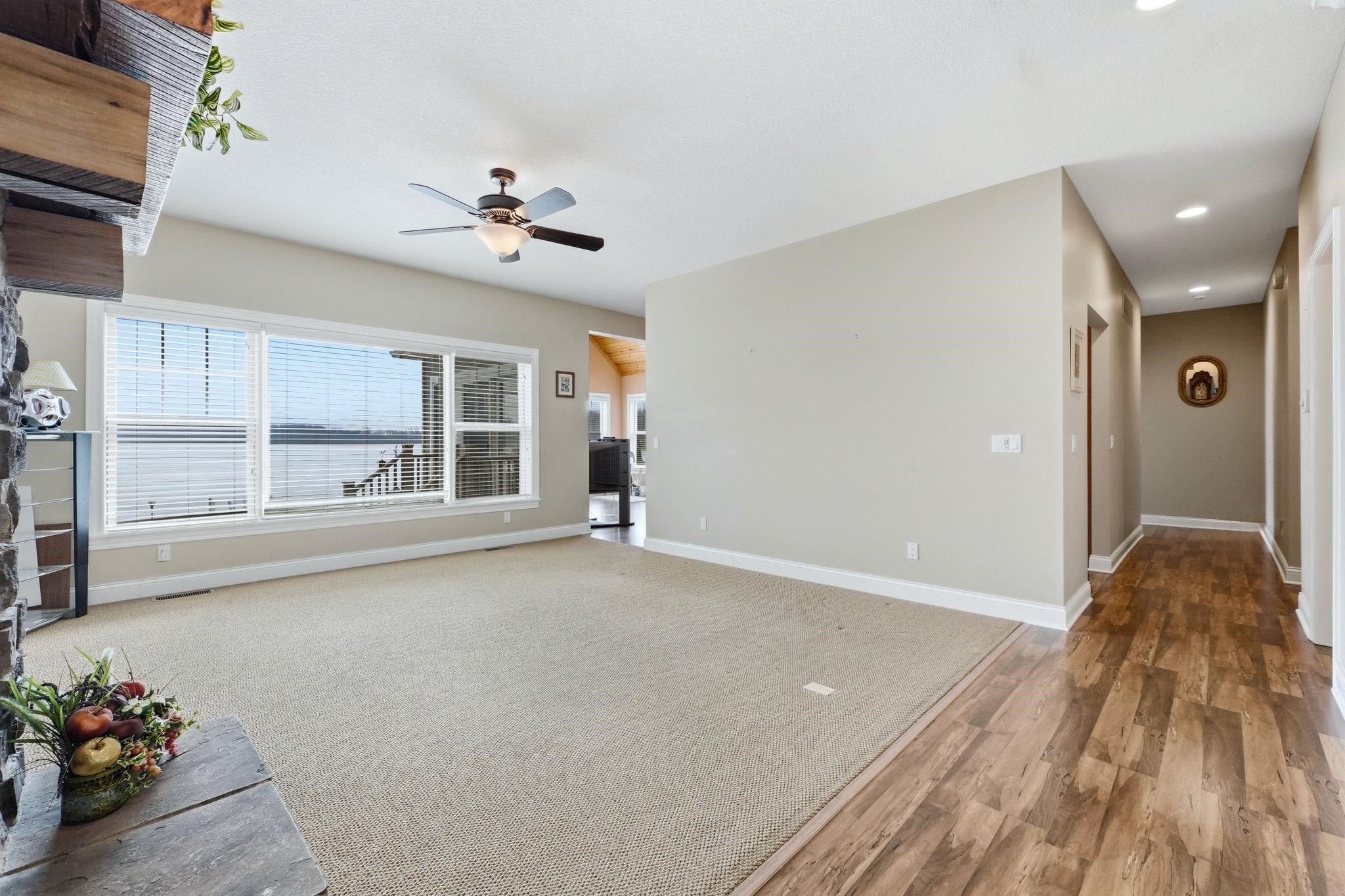 Unfurnished living room with a ceiling fan, light wood-style floors, and recessed lighting
